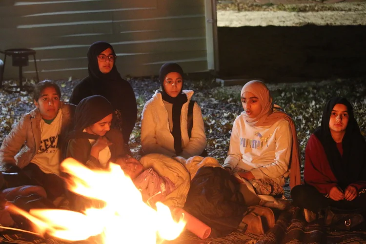 Sisters around a campfire