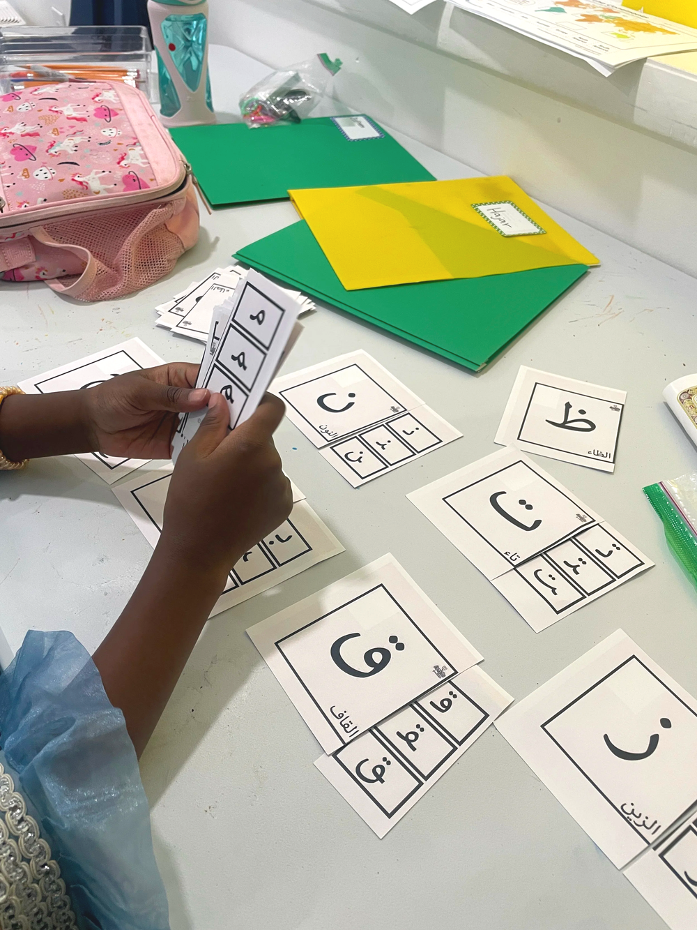 Children learning Arabic letters in the Maktab program