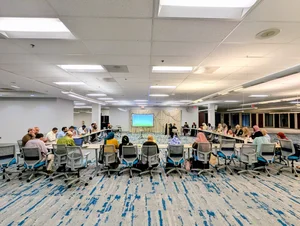 A wide view of the hall set up with rows of tables