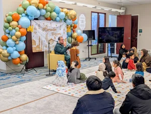 A children's program with a balloon arch in the MFC hall