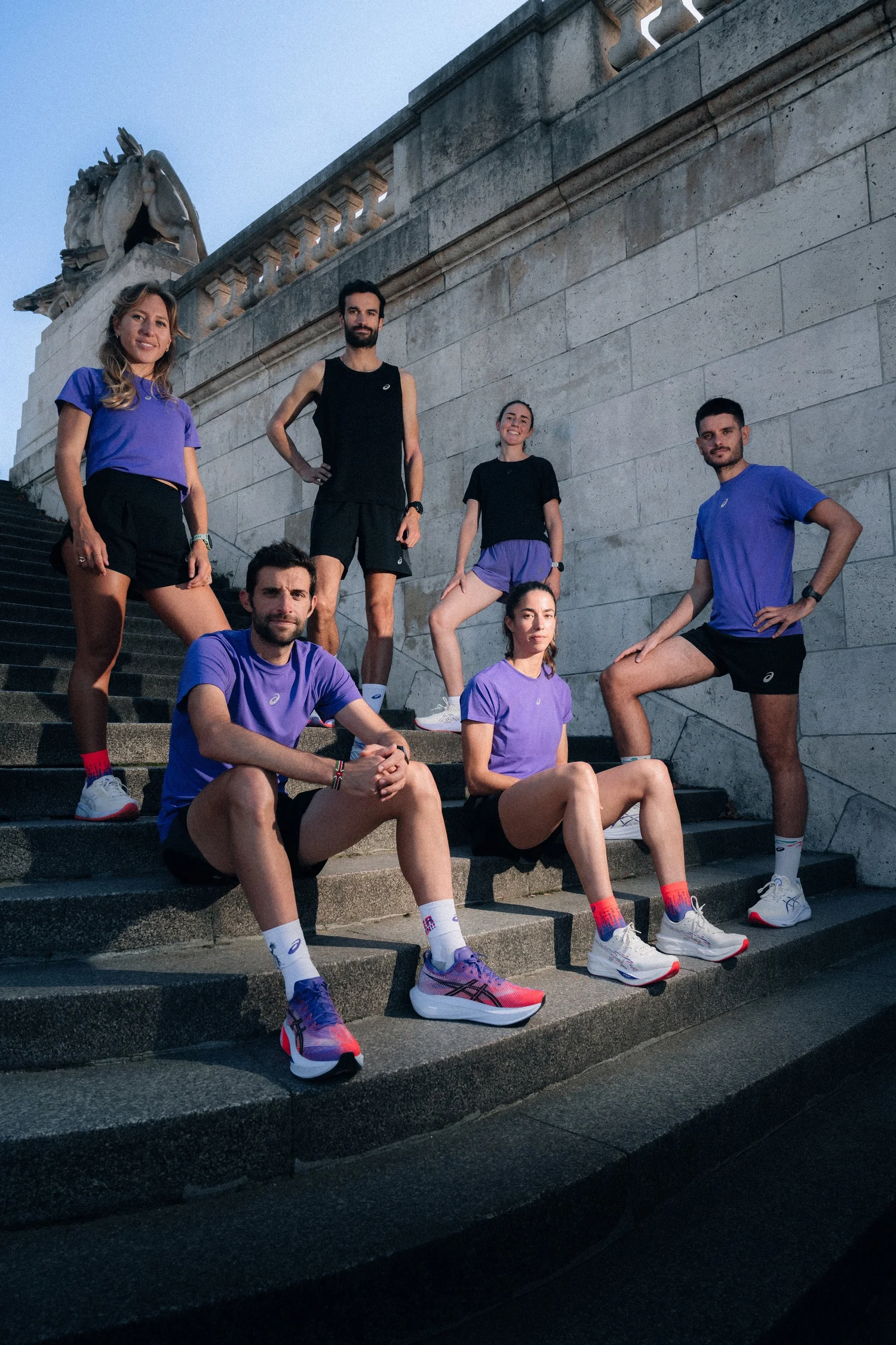 Team de coureurs ASICS posant sur des marches de pierre, campagne de la collection Tokyo