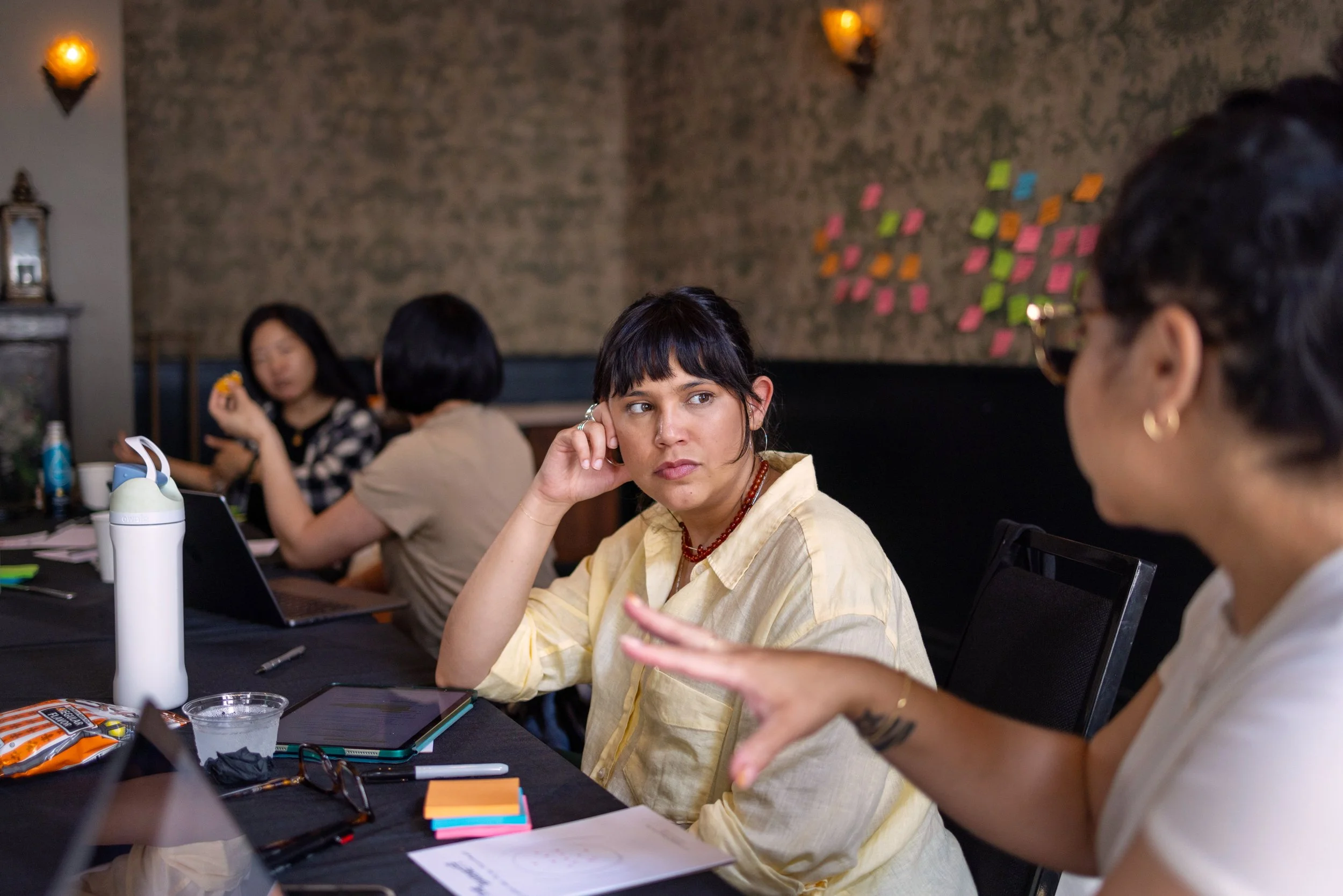 People seated at table in conference room setting