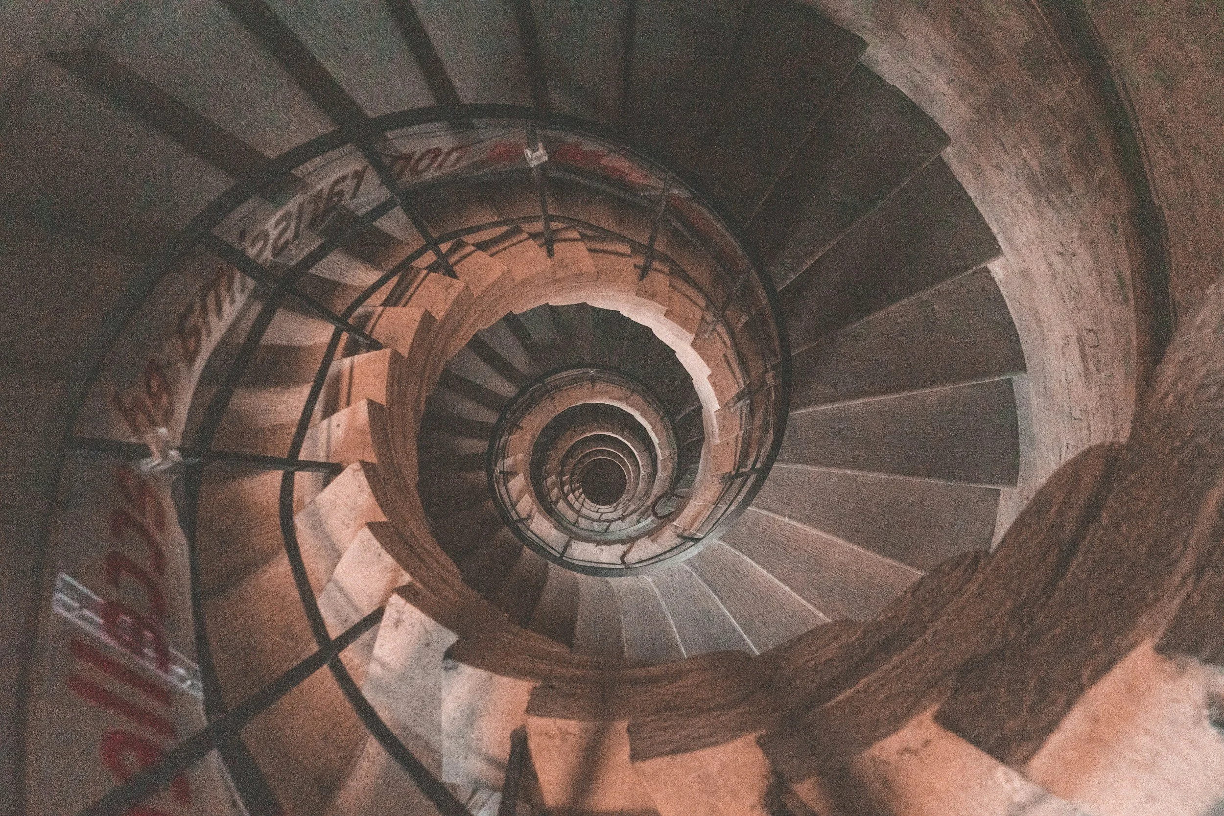 Spiral staircase viewed from above, symbolising how founders repeat patterns around money, success, and responsibility