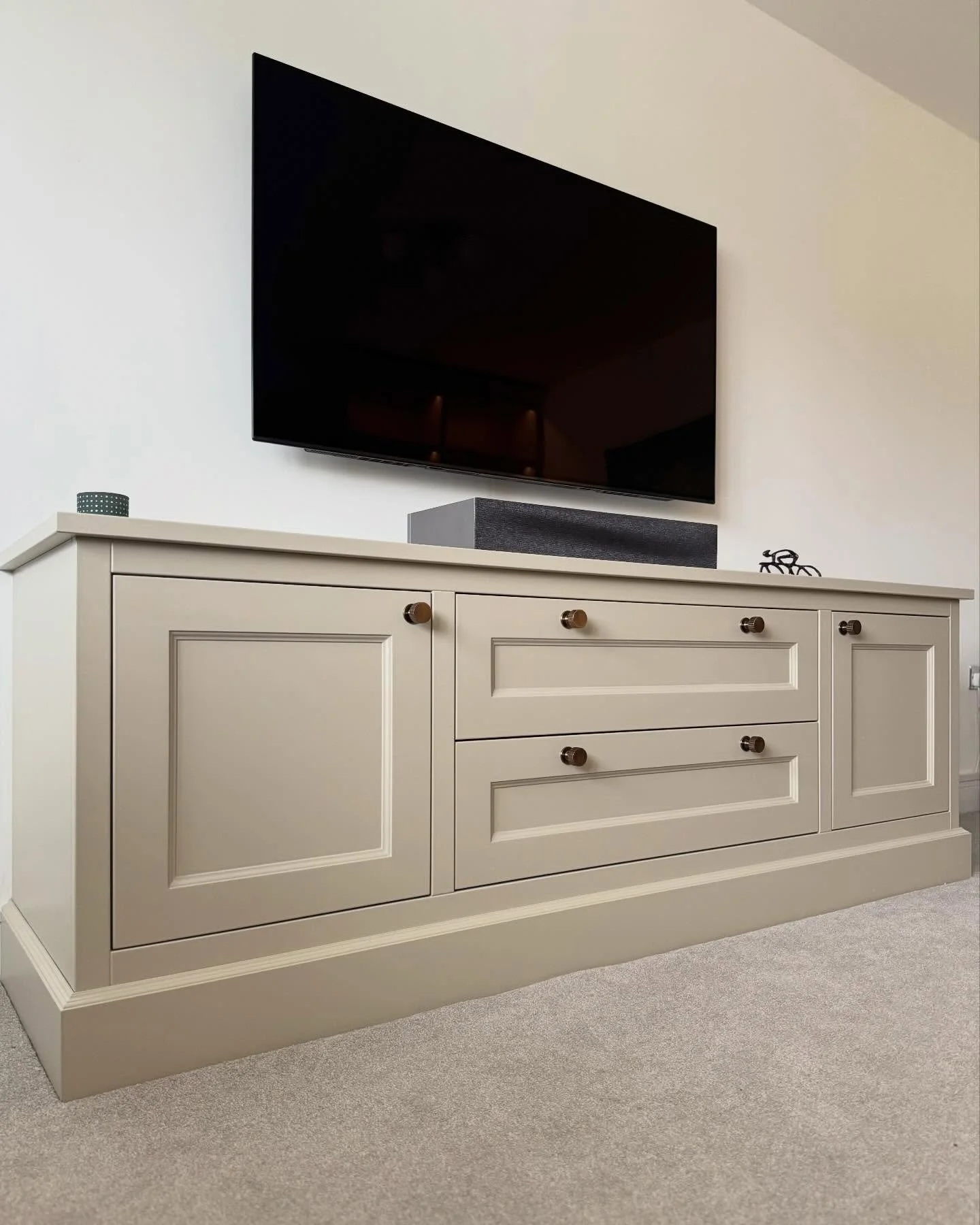 Clean lines, calm proportions, and considered joinery.
This bespoke media unit was completed alongside bookcases set either side of a doorway, designed to complement one another through shared detailing, colour, and hardware.

Painted in Farrow &amp;