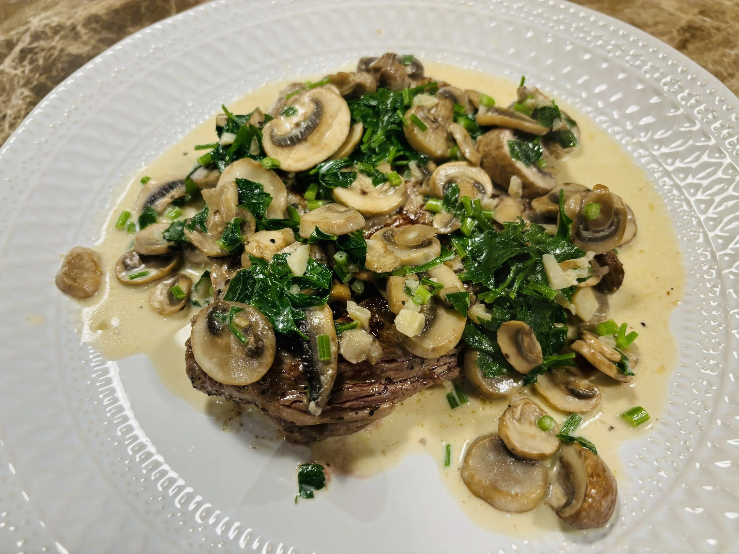Steak with a garlic, butter and mushroom cream sauce.
