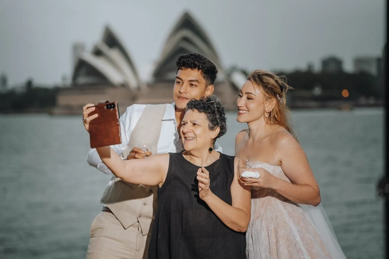 A woman and a man laughing and holding hands in a casual indoor setting.
