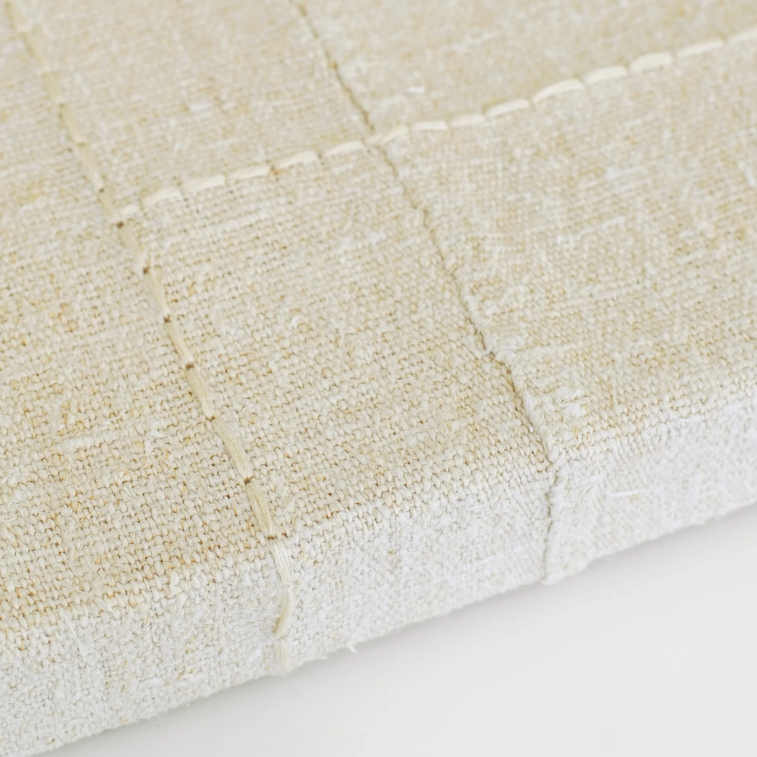 detail of hand-stitched vintage grain sack on canvas.