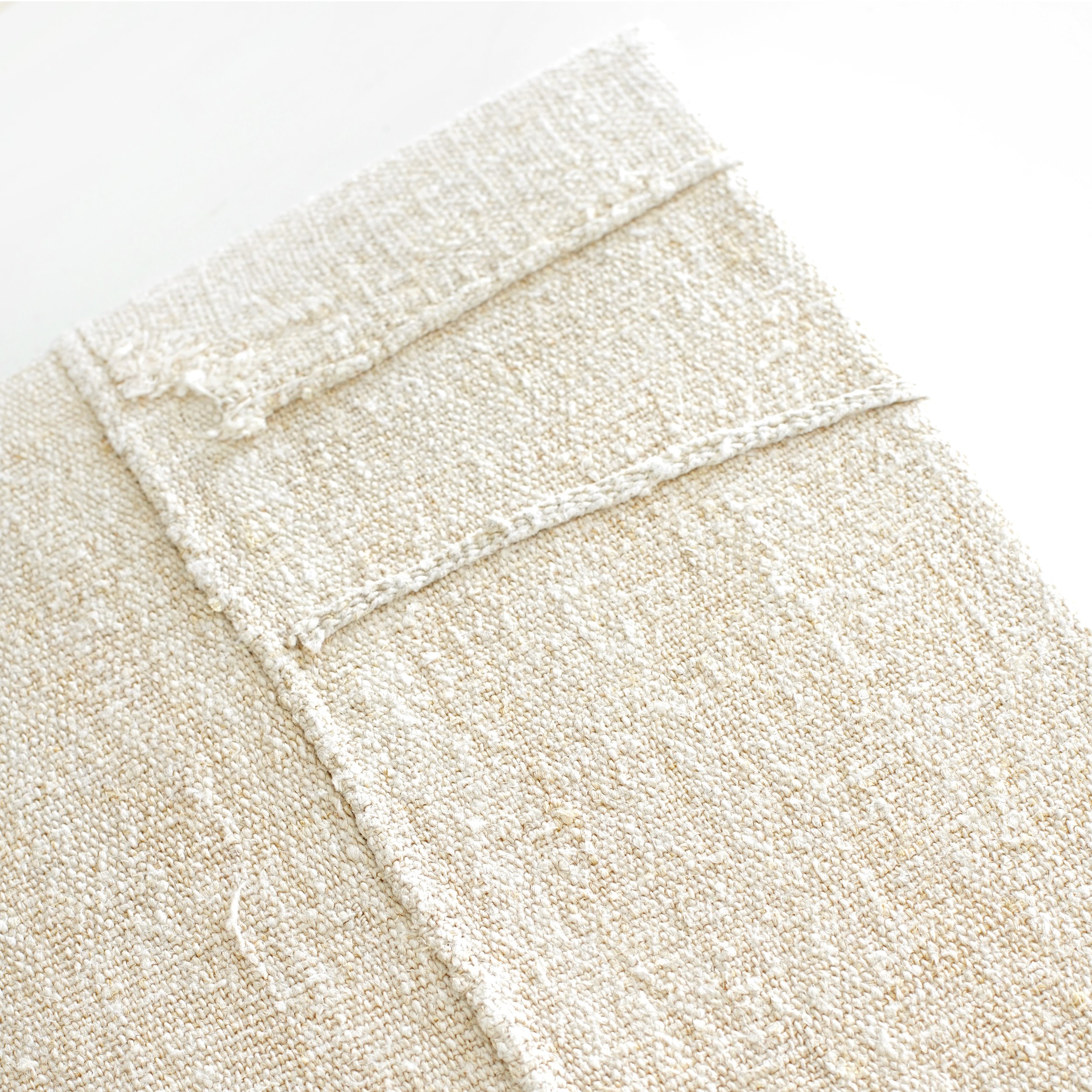 detail of hand-stitched vintage grain sack on canvas.