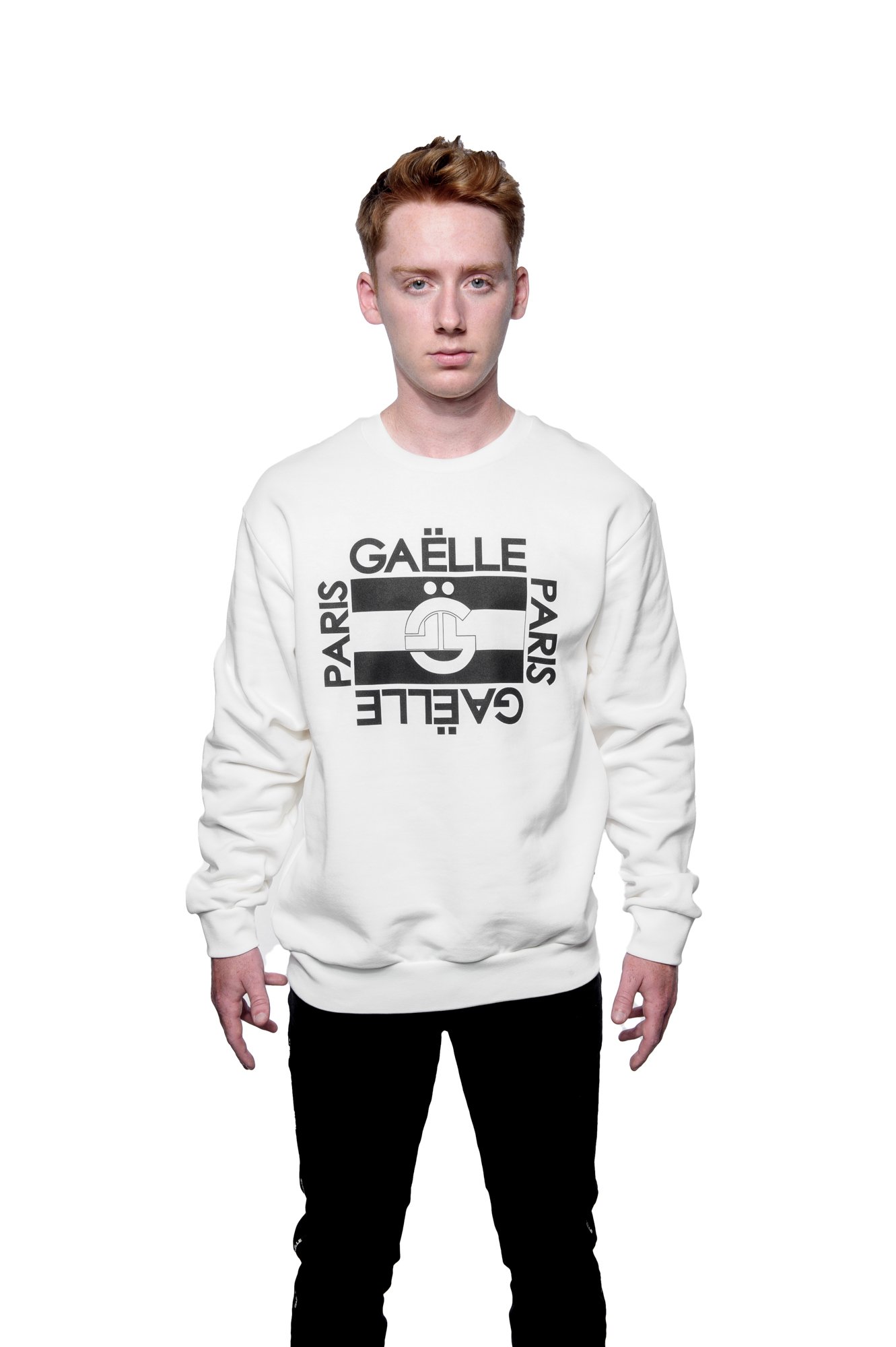 Person wearing a white sweater with "GAËLLE PARIS" text design, isolated on white background.