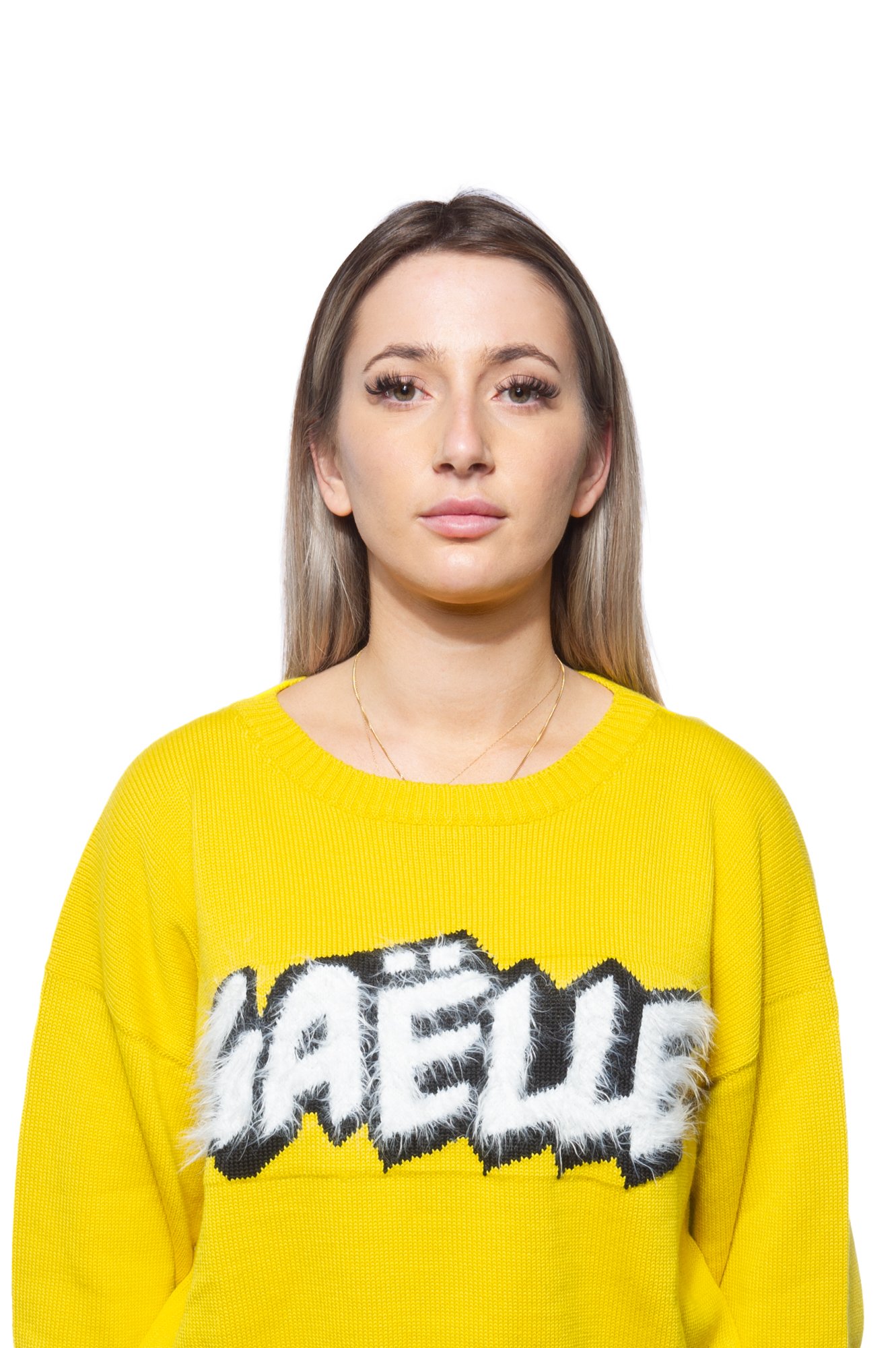 Person wearing a yellow "GAËLE" sweater