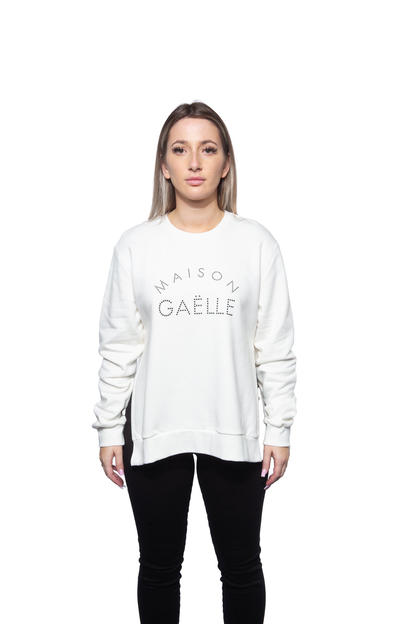 Person wearing a white "Maison Gaëlle" sweatshirt and black pants against a white background.
