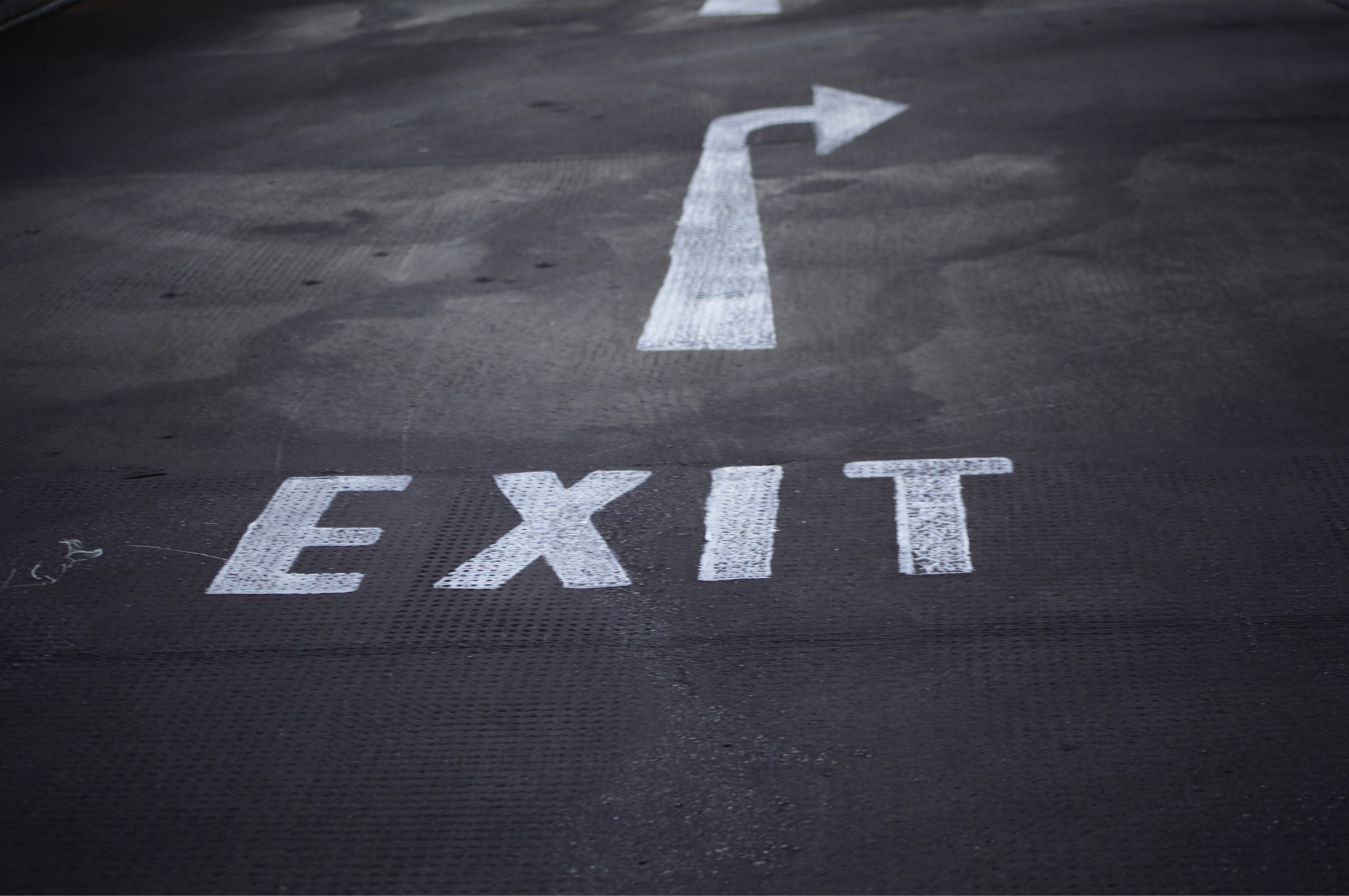 Image of exit and arrow written on street