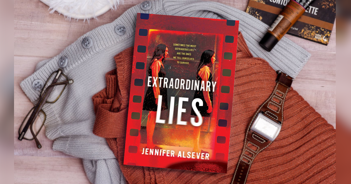 The image shows a book titled 'Extraordinary Lies' by Jennifer Alsever resting on a pile of clothing, including a gray button-up sweater, a rust-colored sweater, and a black watch with a brown band. There are also a pair of glasses and some cosmetic items nearby on a wooden surface.