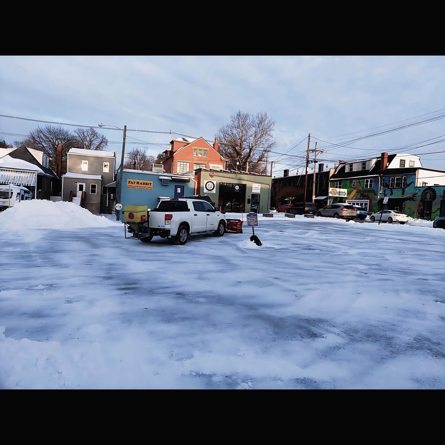 Back lot hath been plowed and salted!