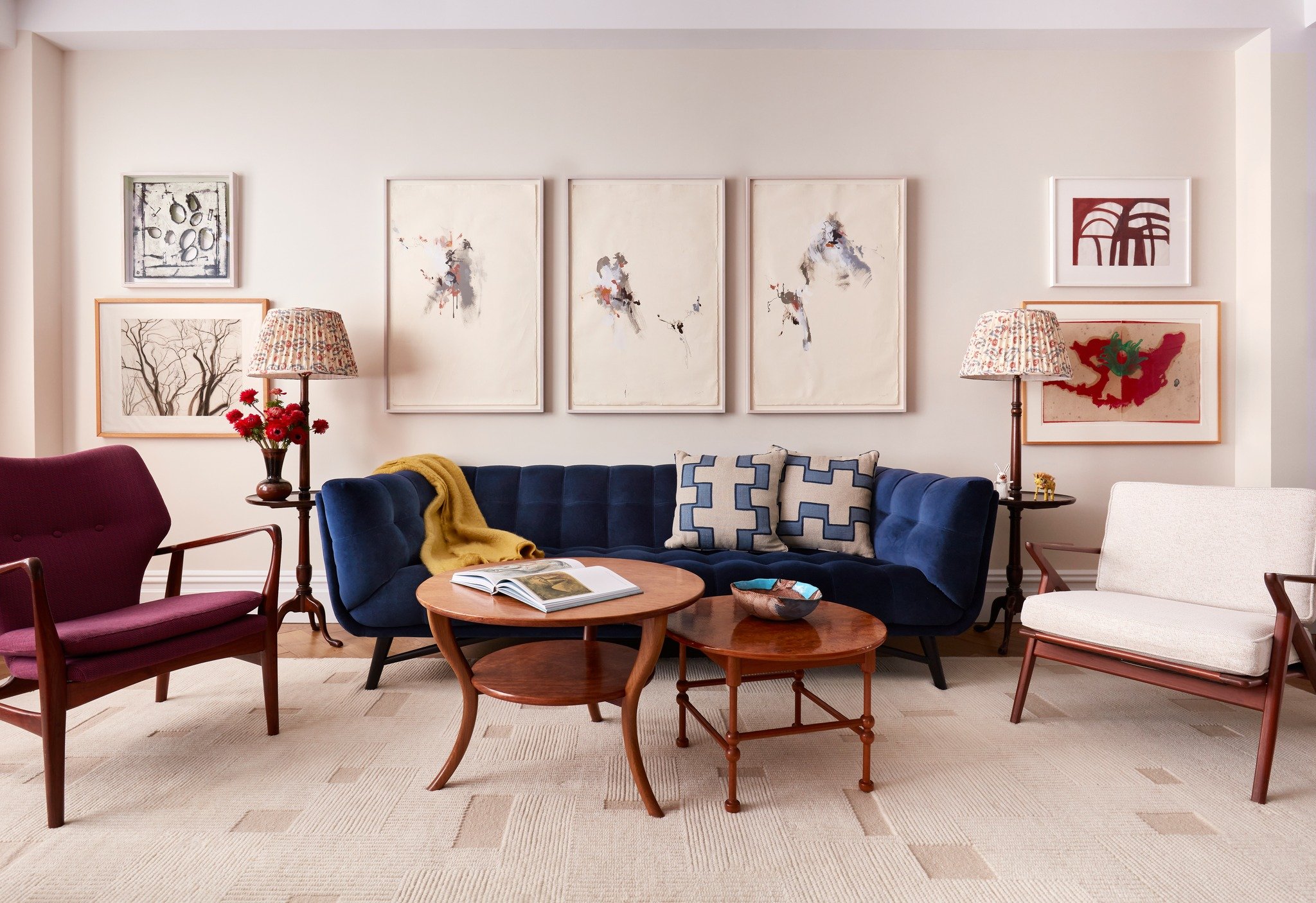 Calm, cool and collected. This is one of my favorite views of the living room of a recent project. A navy velvet sofa grounds the living room. Reupholstering vintage chairs gave them a second life, and new lampshades updated the client's own lamps. A