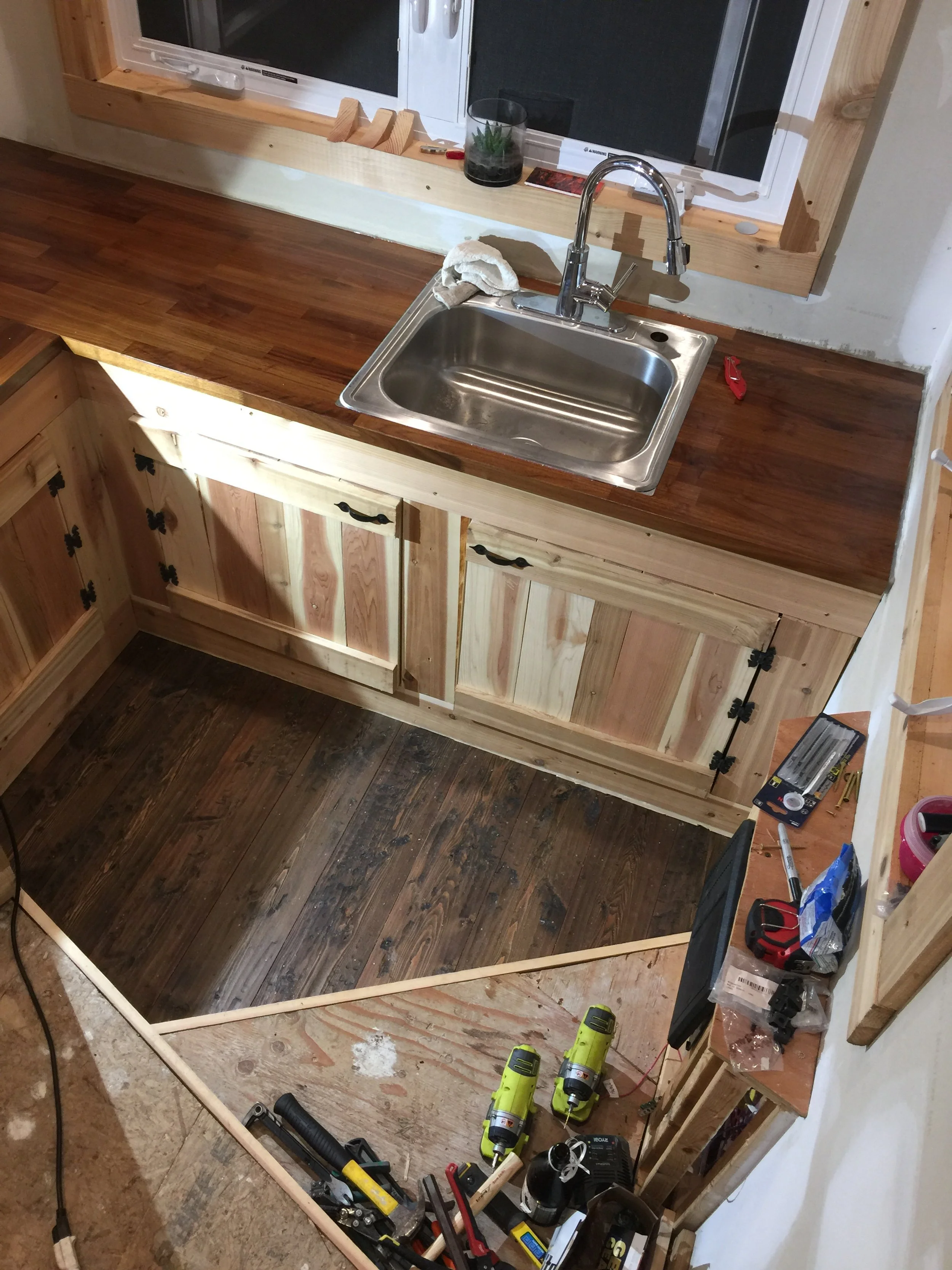 Galley kitchen with custom cedar cabinets and cast iron hardware. 