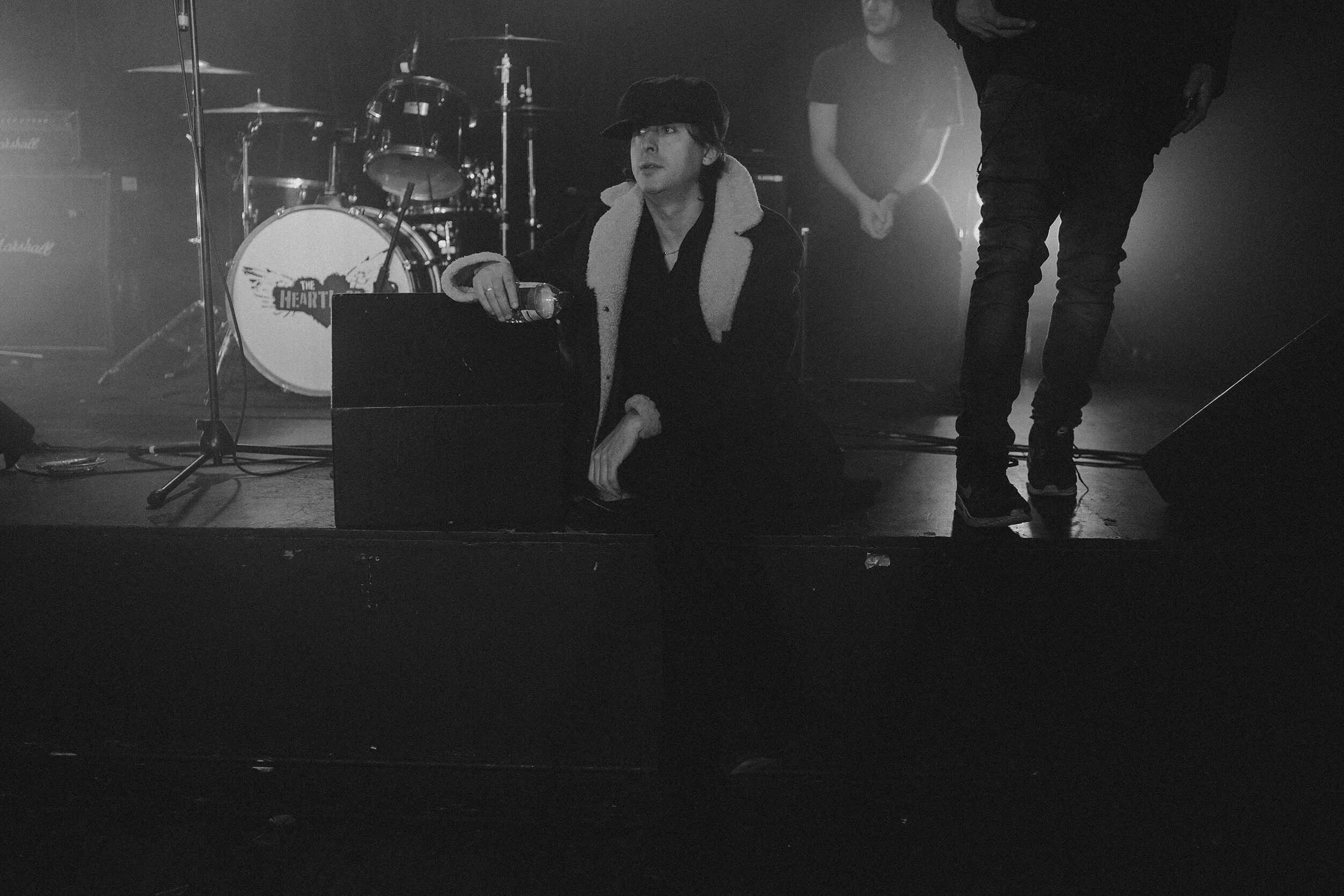 carl barat sitting on a stage
