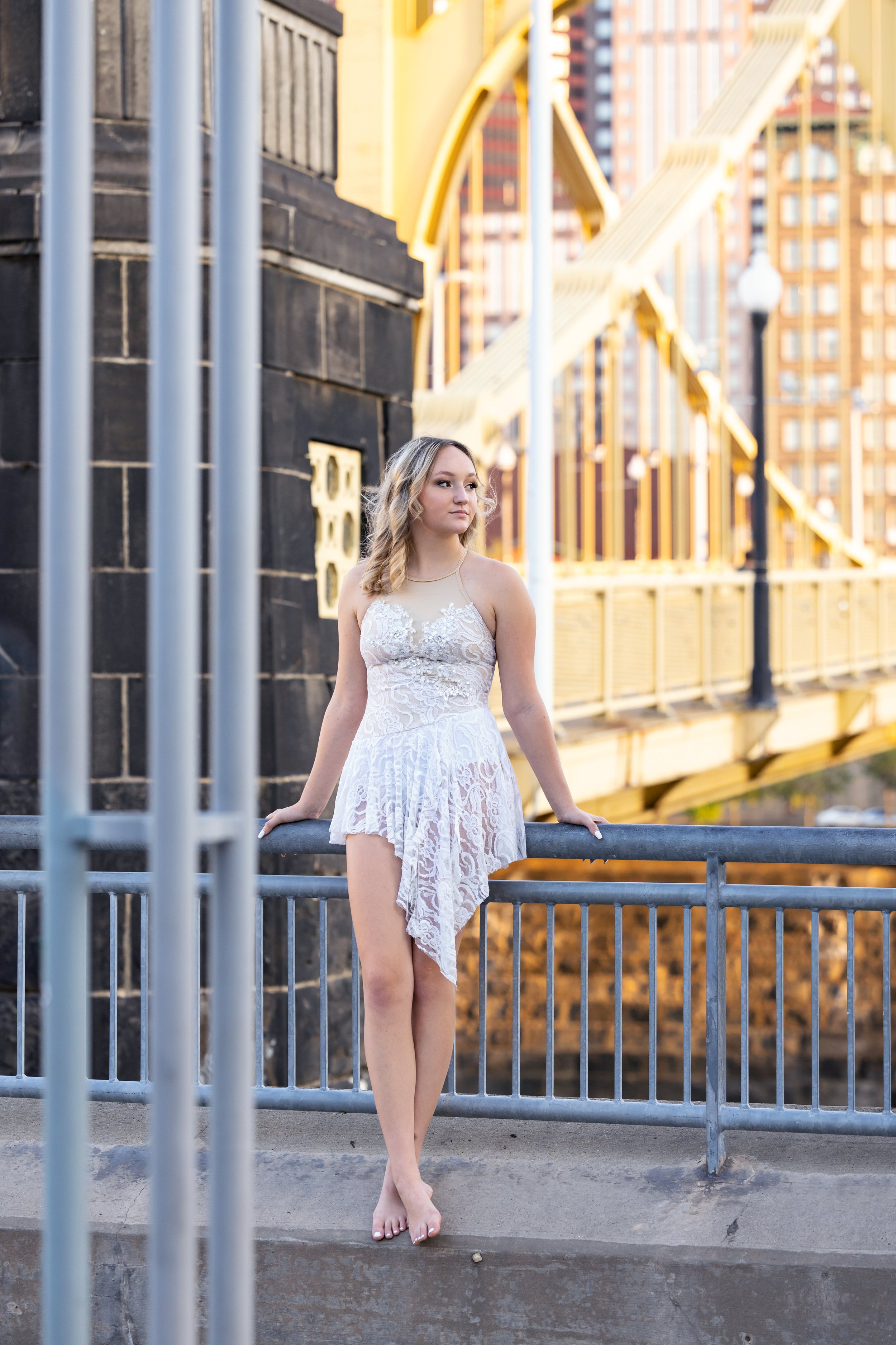 senior photo of dancer posing on yellow bridge Pittsburgh