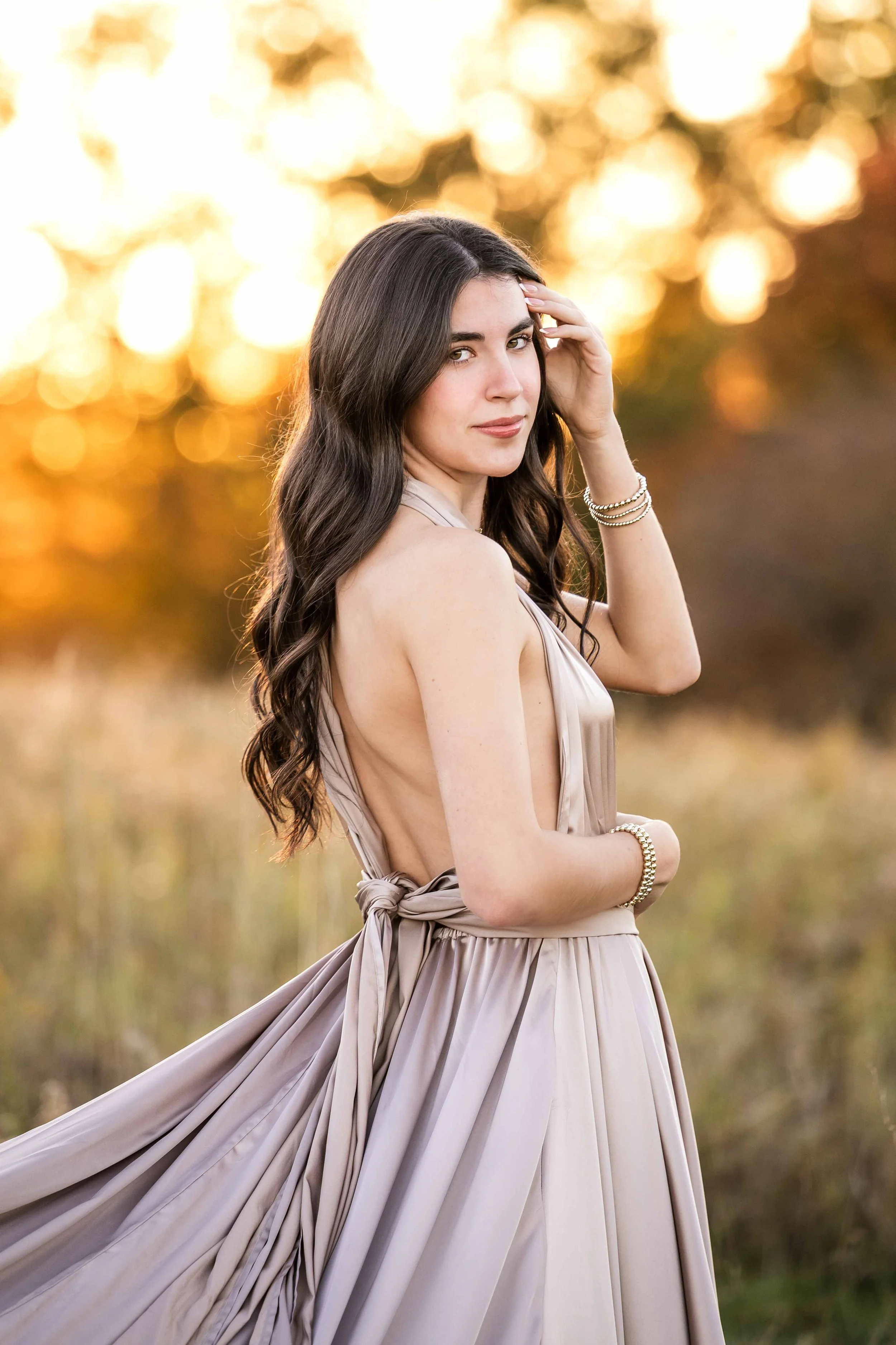 senior photos girl in blush dress in field