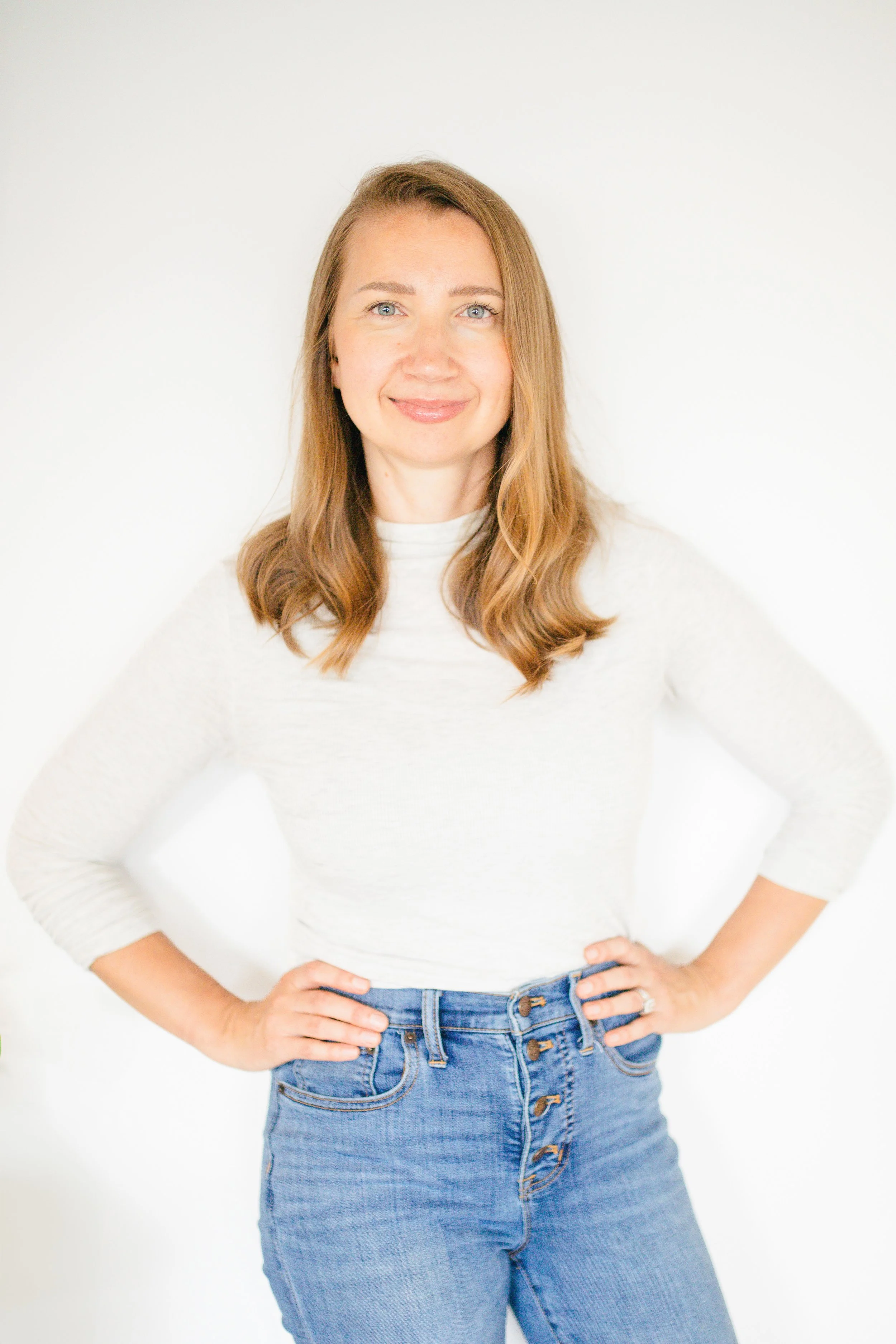 Irina Baechle, LCSW, marriage counselor in Raleigh NC and Wake Forest NC is standing and smiling in her marriage counseling office in Wake Forest, North Carolina