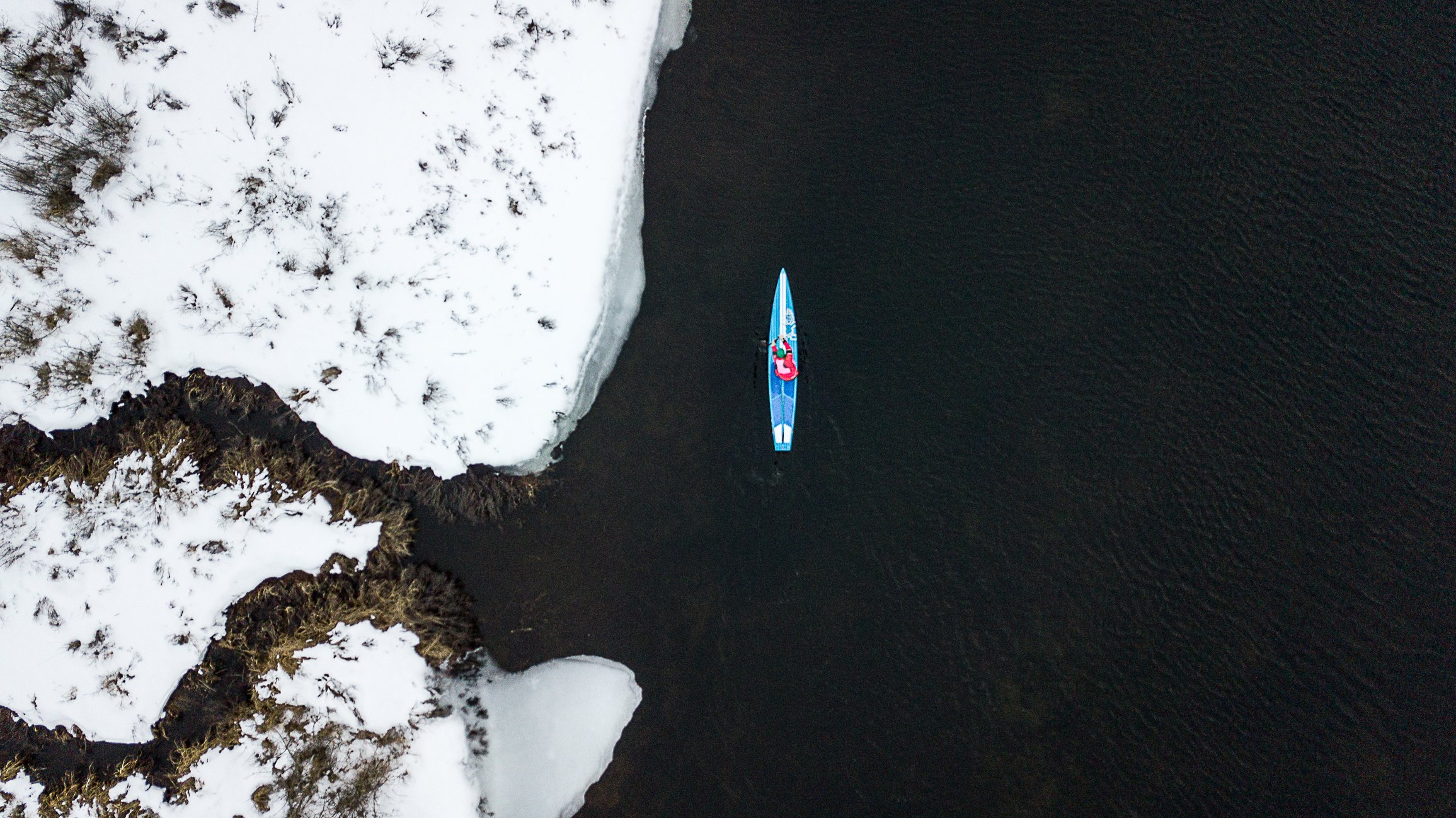 Courtney Sinclair paddles her SUP board on open water in winter_.jpg