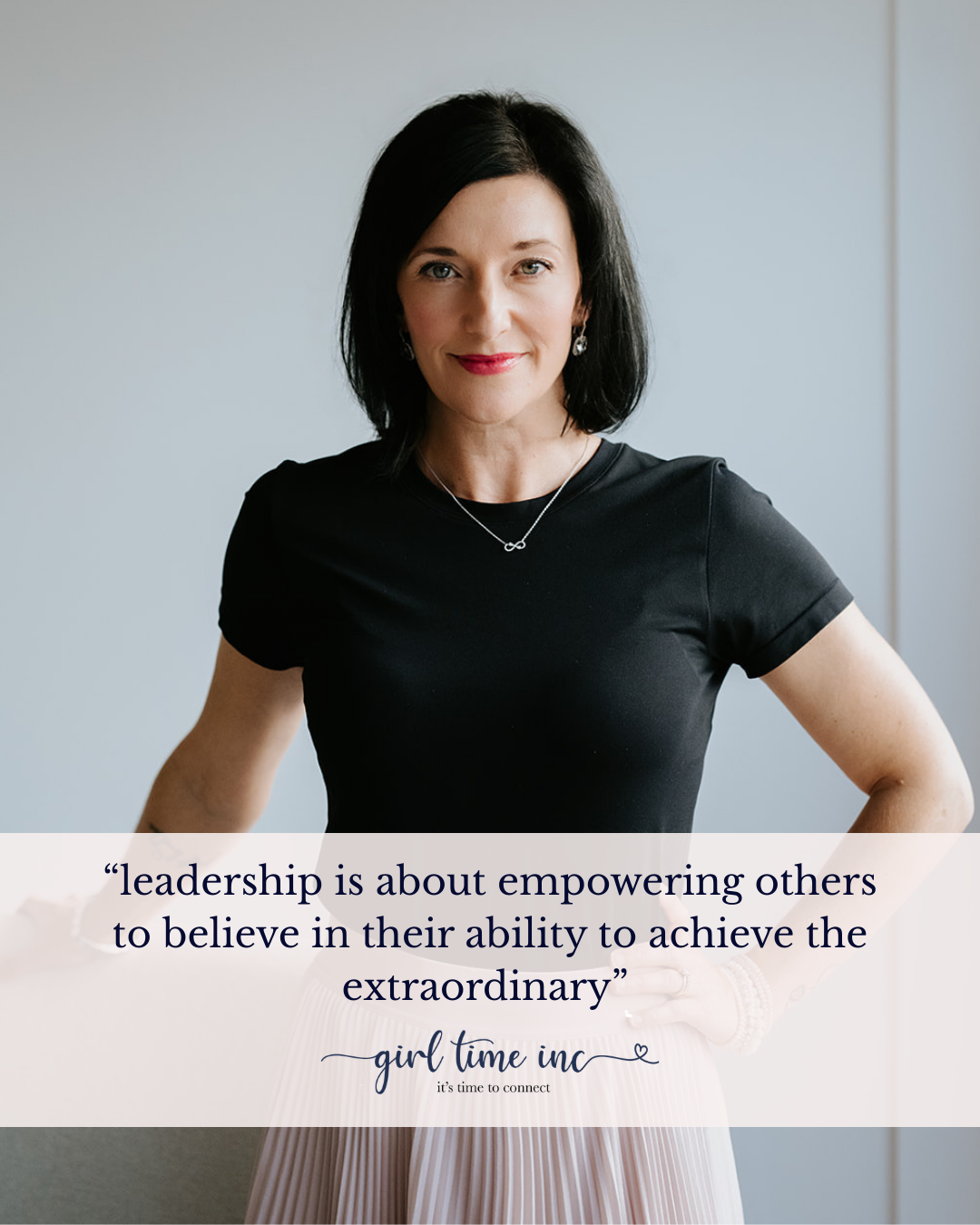 A woman with black hair wearing a black top and jewelry standing against a plain background, with a quote overlay saying, 'leadership is about empowering others to believe in their ability to achieve the extraordinary' by girl time inc.