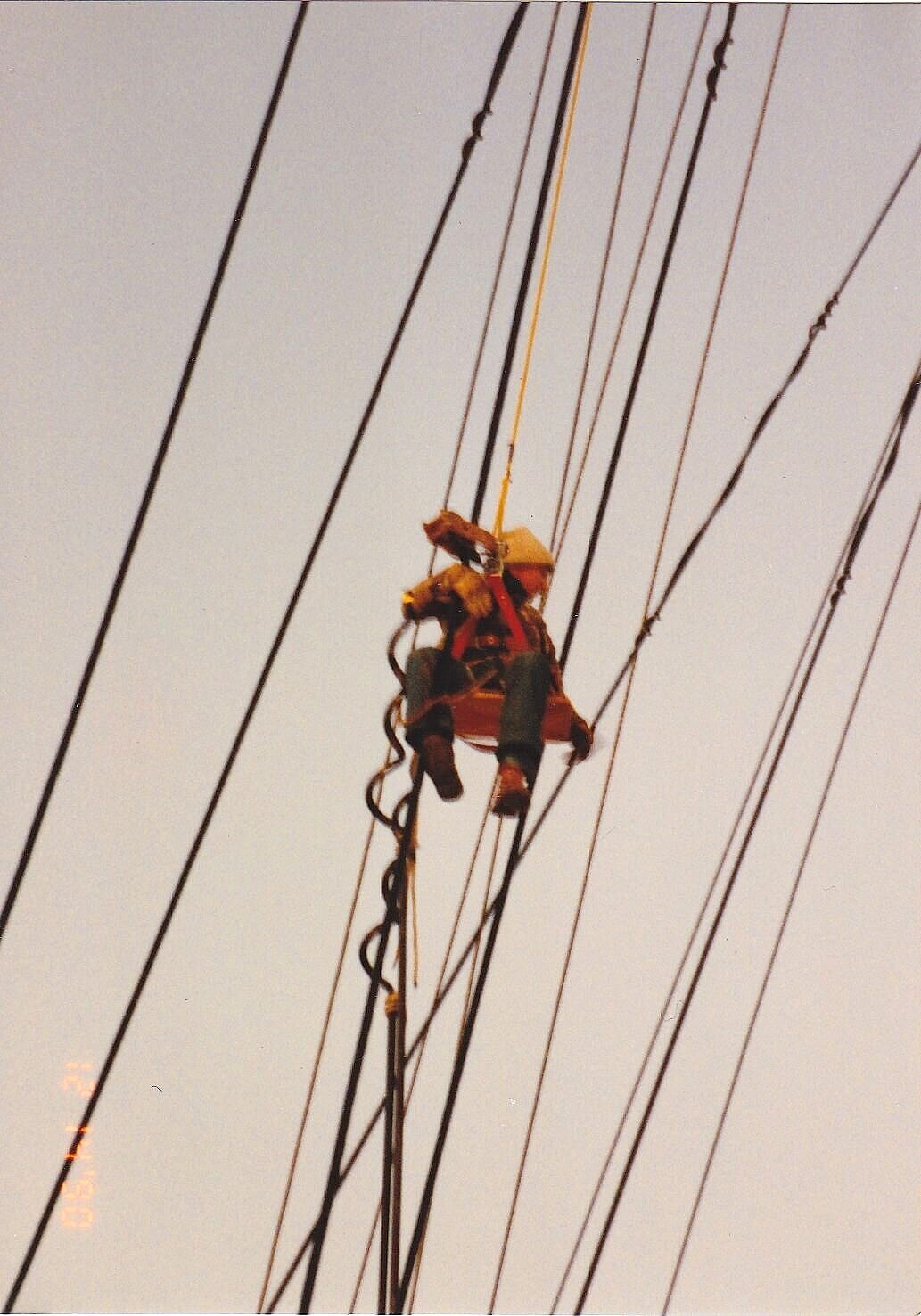 worker suspended among mix of cables