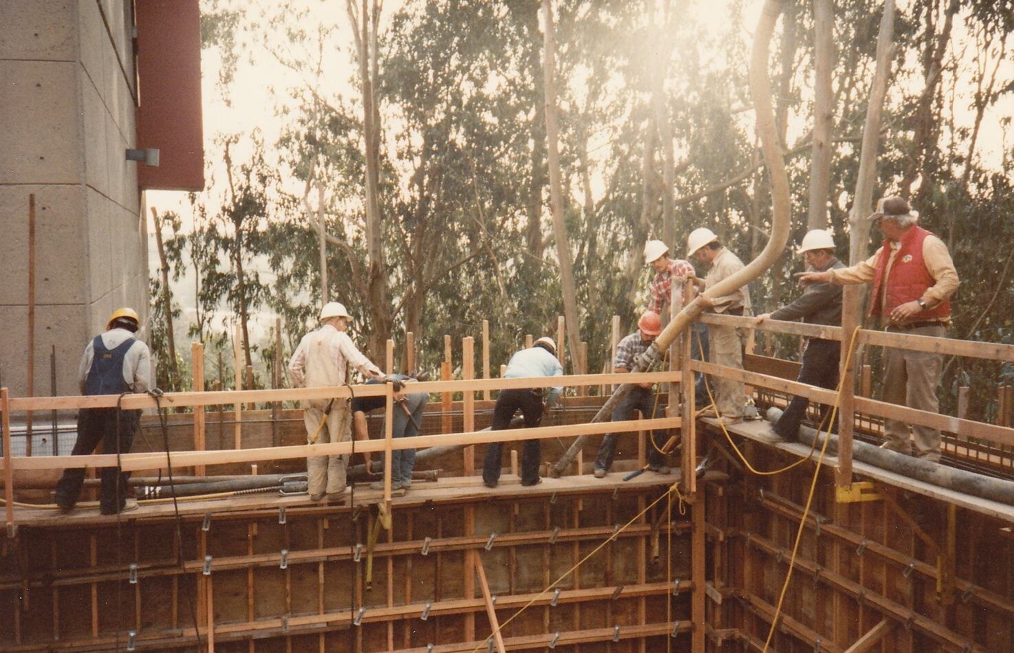 another view of workers building wood base