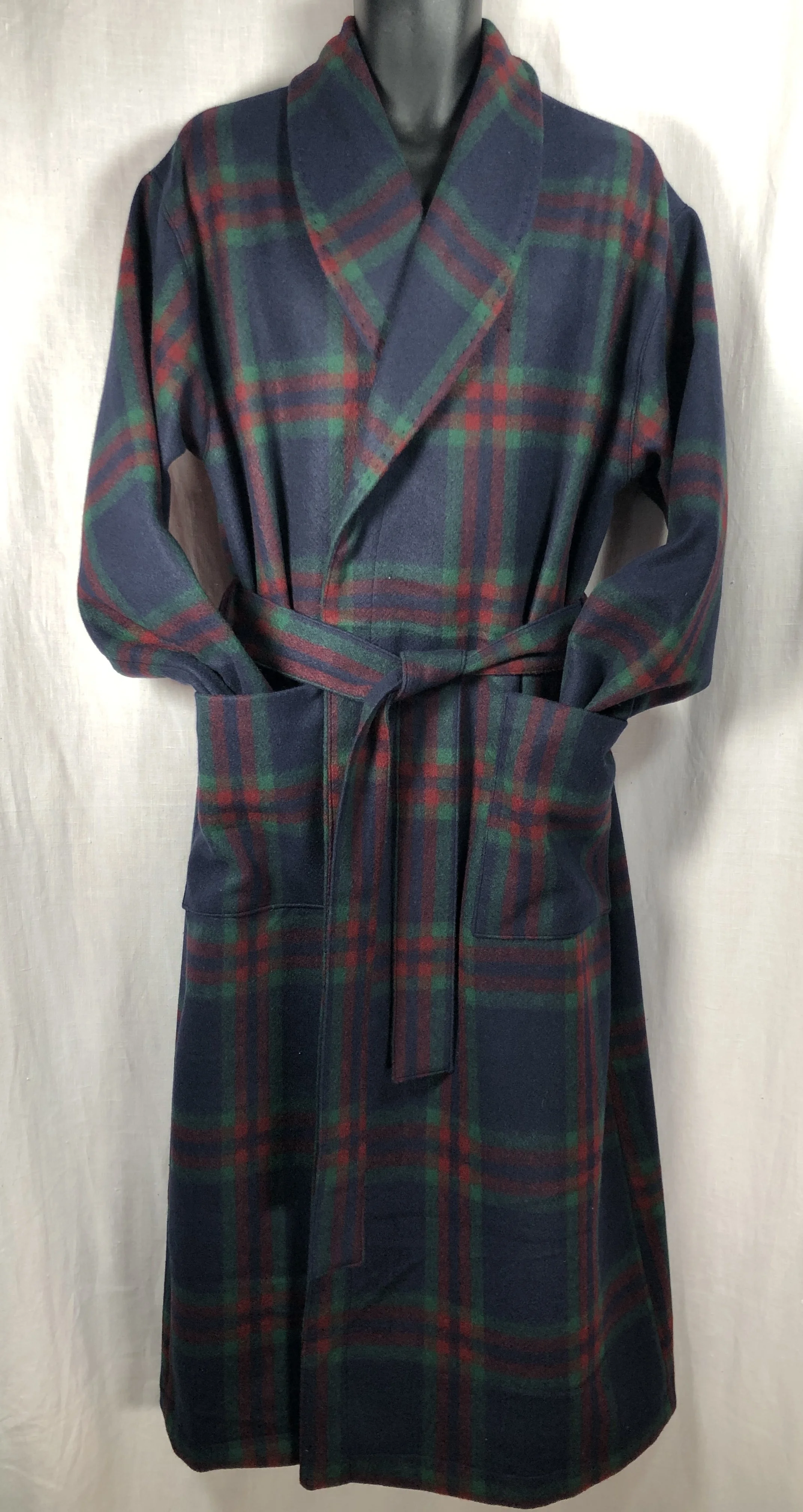 A long, plaid wool bathrobe with a belt, featuring on the fabric a tartan pattern in navy, green, red, and yellow, displayed on a mannequin against a plain background.
