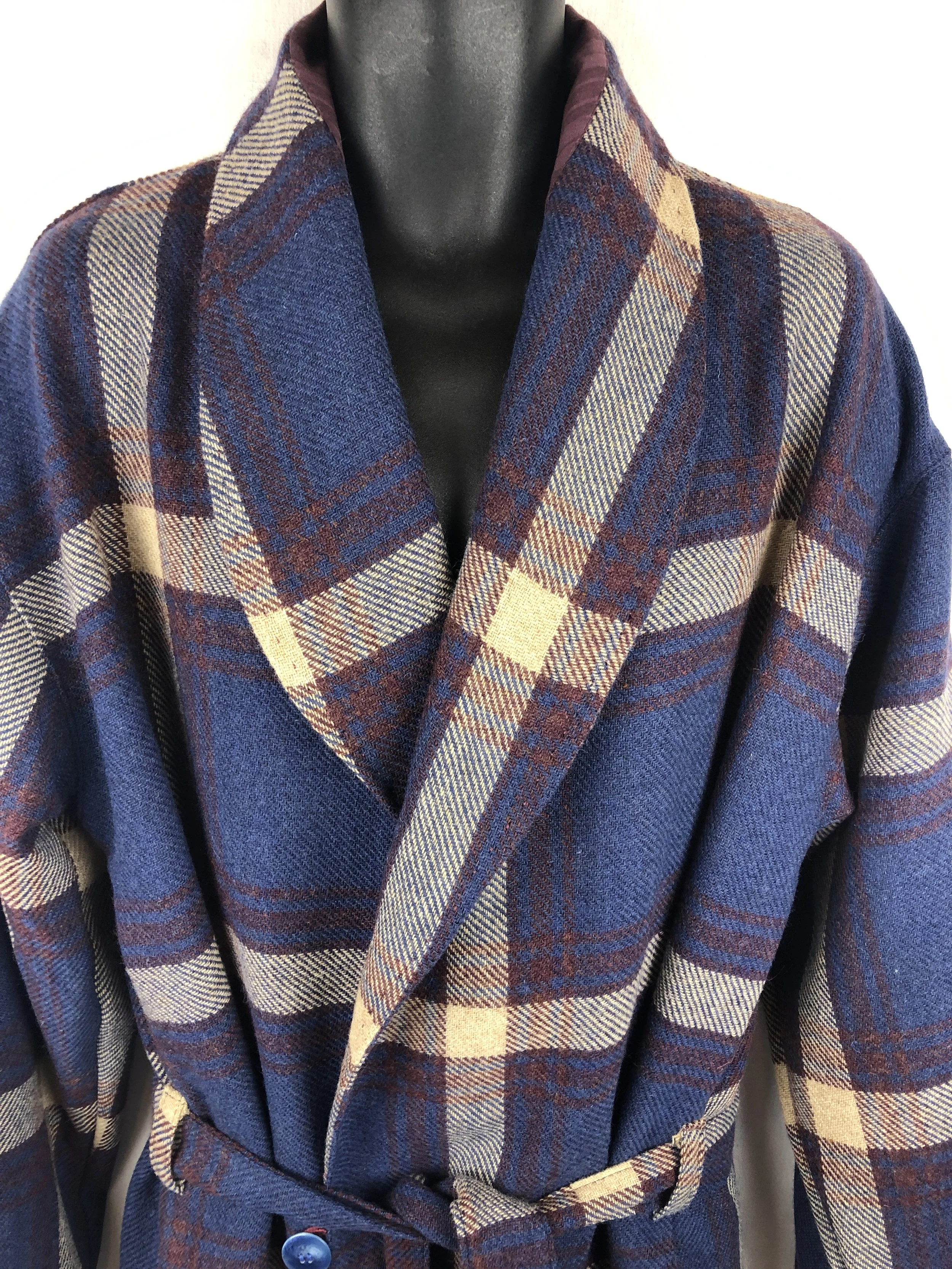 A mannequin dressed in a blue, brown, and beige Italian wool dressing robe with a belt.