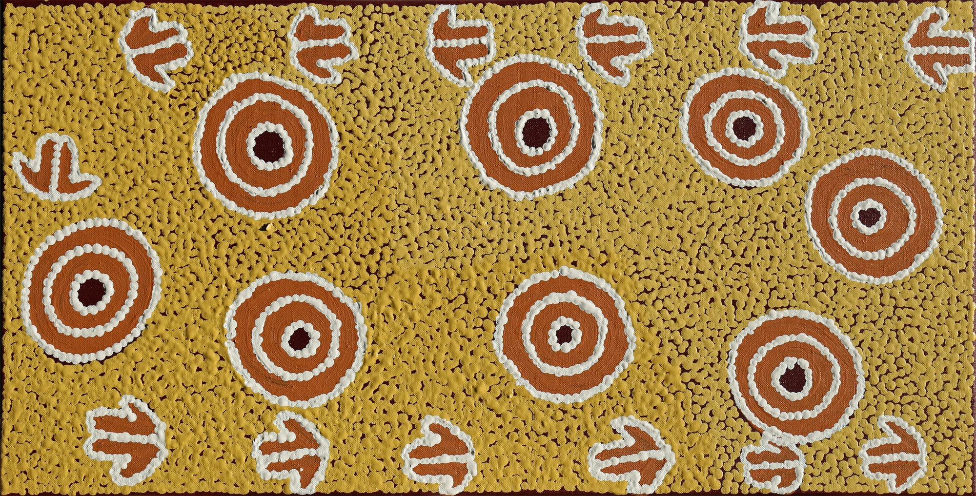 Isobelle Spencer   Marlu Jukurrpa, &nbsp;  #10045-20  310 x 610 mm Acrylic on Linen   $220   This Marlu Jukurrpa, or Kangaroo Dreaming belongs to Japaljarri / Jungarrayi men. A father and son follow Kanyarla [Rock Wallaby], like a small kangaroo. They start the journey from Munyunpu near Mt Denison moving to another place called Kirripungu, near Wakurlpa, north east of Yuendumu. Kanyarla sits down in the shade at Kirripungu. The Marlu [kangaroo] tracks are shown as arrow-like shapes. The small circles represents mulju or water soakages along the path they all take. The men are shown with their Spears and Number 7 Boomerangs.&nbsp; This Ancestral story belongs to the Spencer sisters, their father, father’s father, and brothers.   ENQUIRE