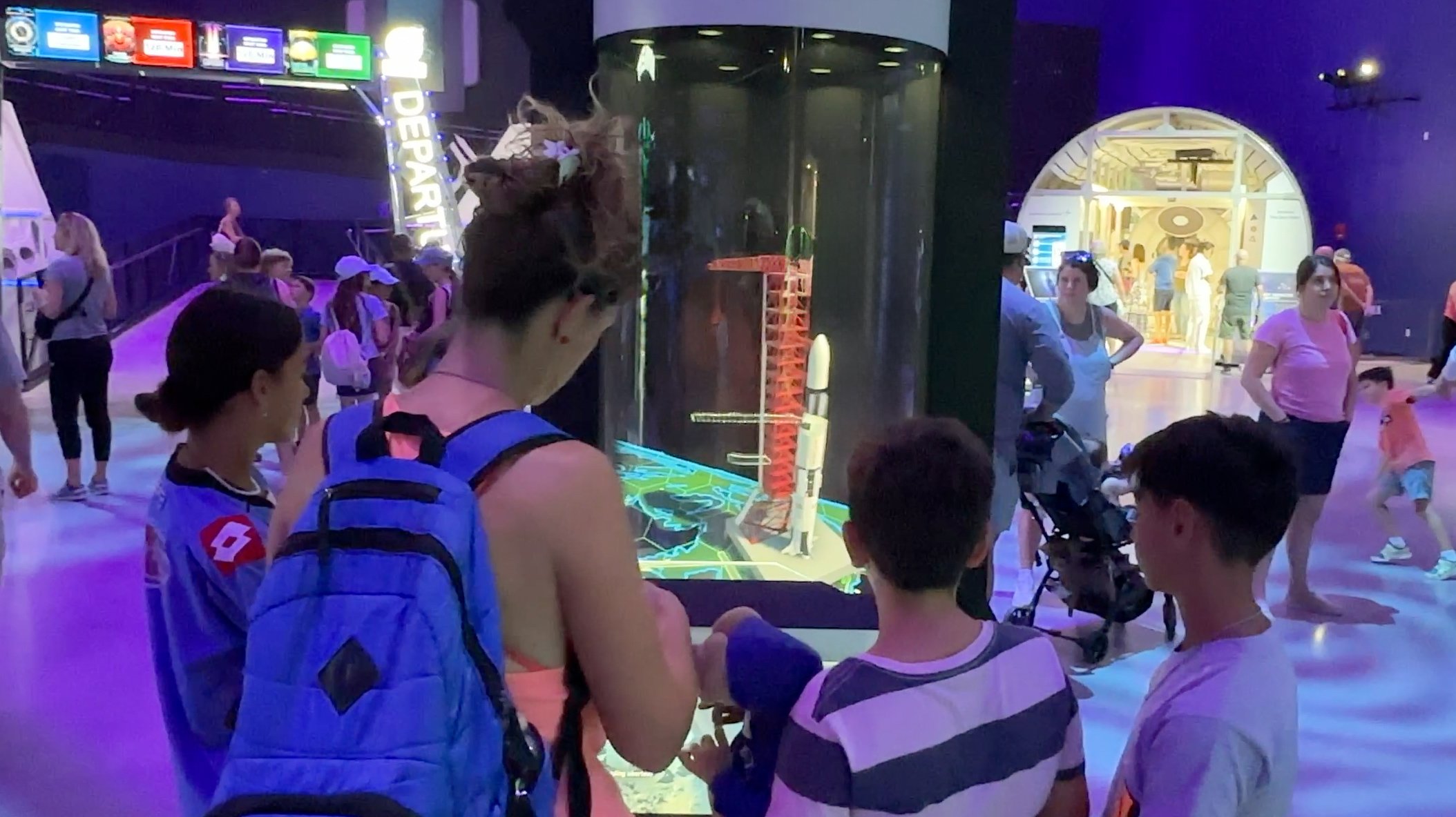    A young audience captivated by the holographic display of a rocket at the Kennedy Space Center.   