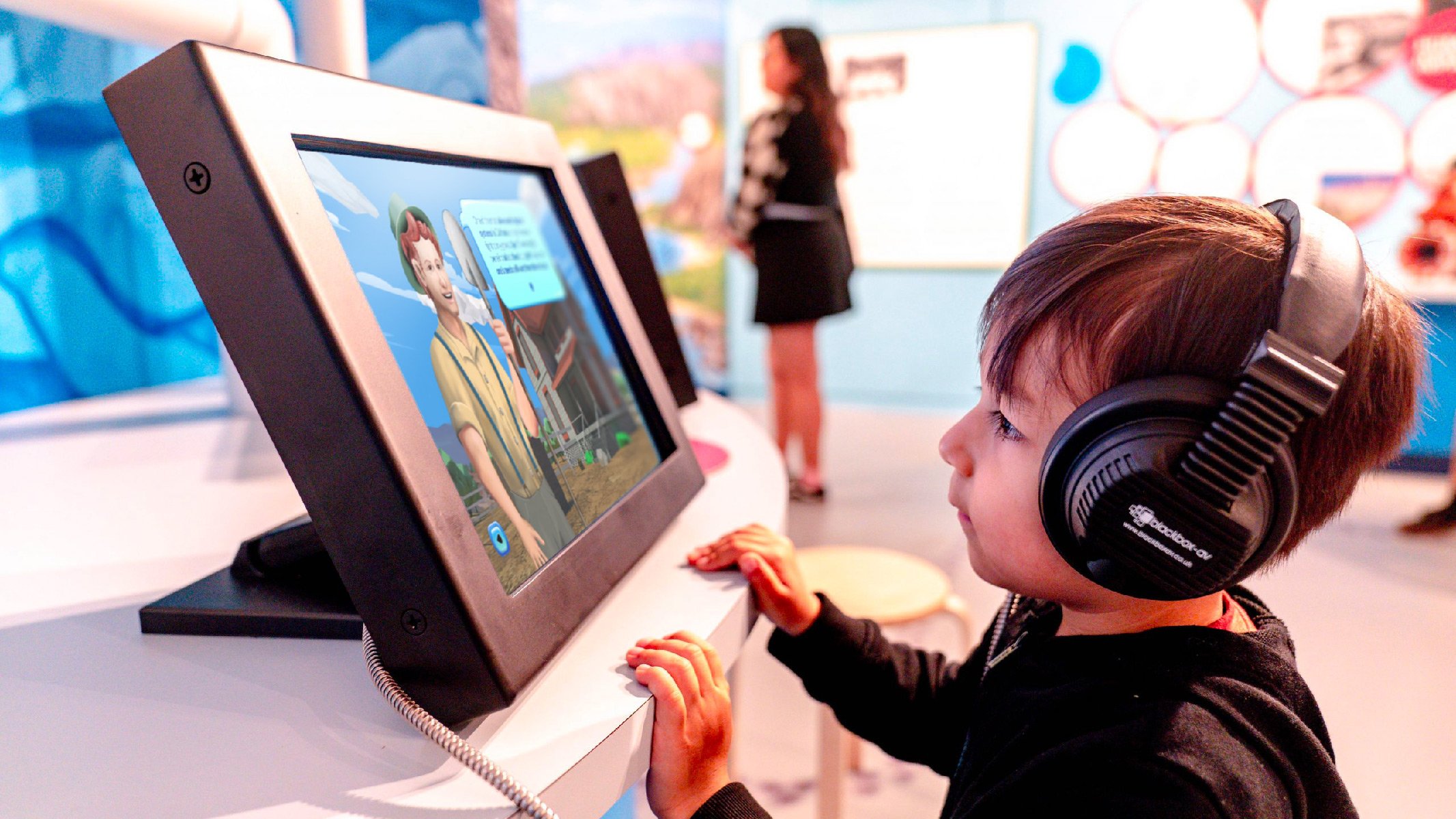    A young museum guest engages with 'Water Keepers' at the Ontario Museum, discovering water management through interactive play.   