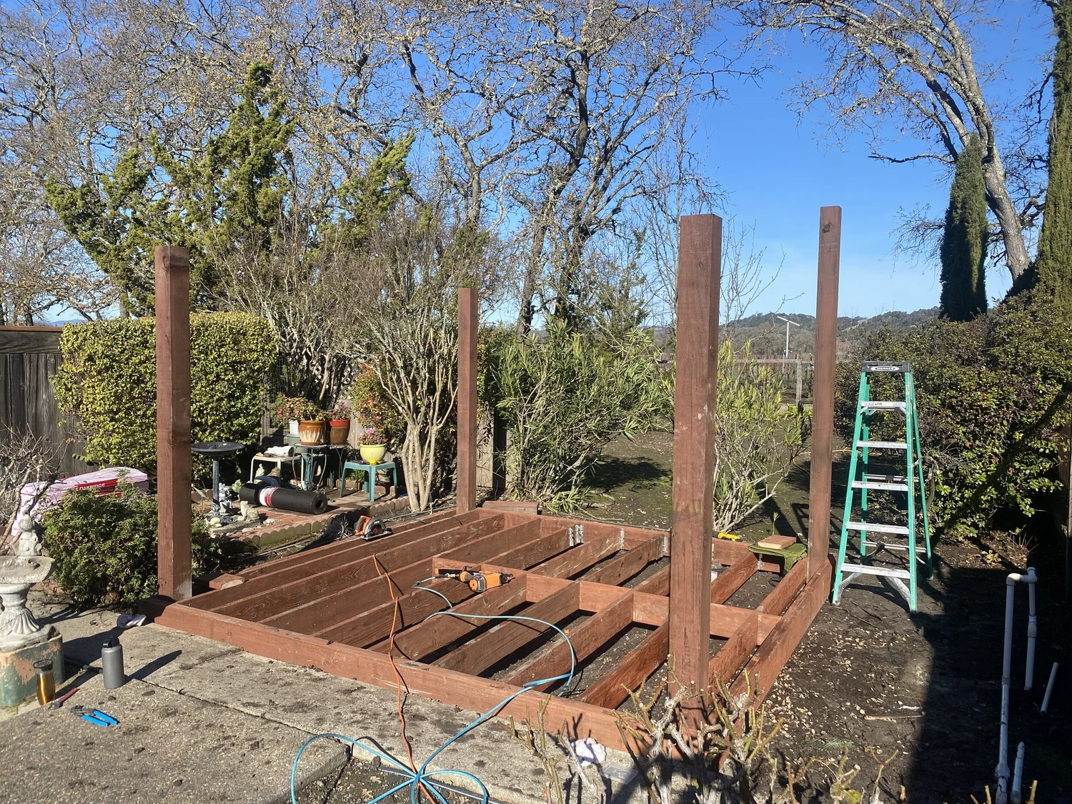 Gazebo framing under construction beside pool