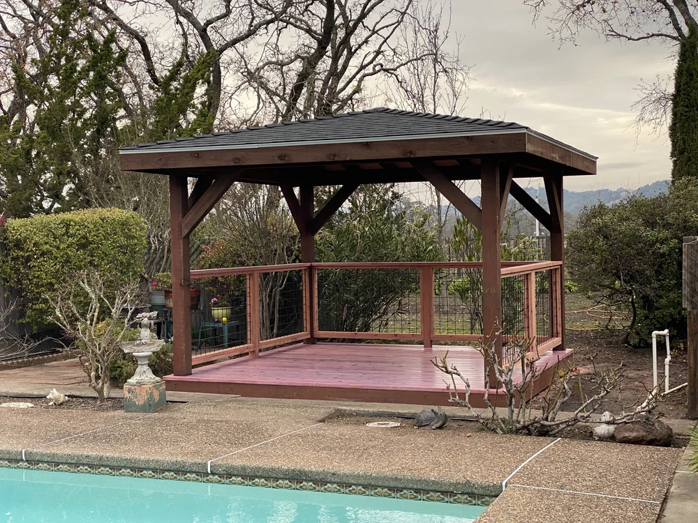 Finished poolside gazebo with shingled roof