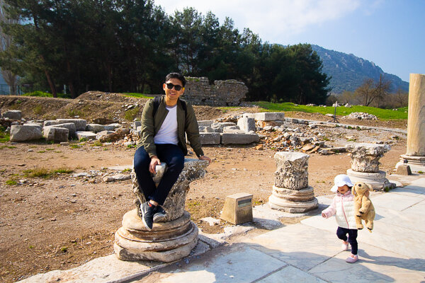 Paolo sitting on a Corinthian-style column on the marble walkway leading to the harbor. This style column is named after the city of Corinth, where the sculptor/inventor invented it after seeing a goblet surrounded by leaves.