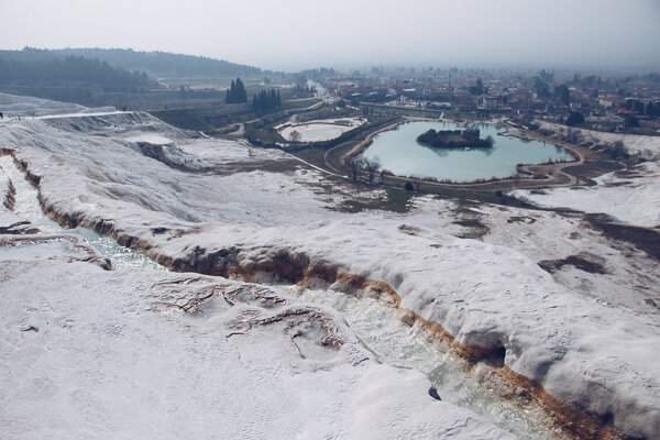 The hot spring waters flowing through Pamukkale and the view of the plain.