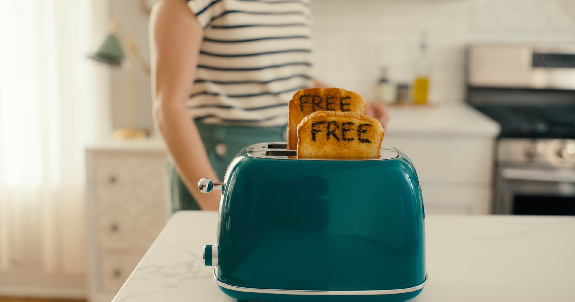 Film still from Twin Lakes internet and Trilight Mobile bundling commercial, showing two pieces of toast that both have the word "free" singed on them.