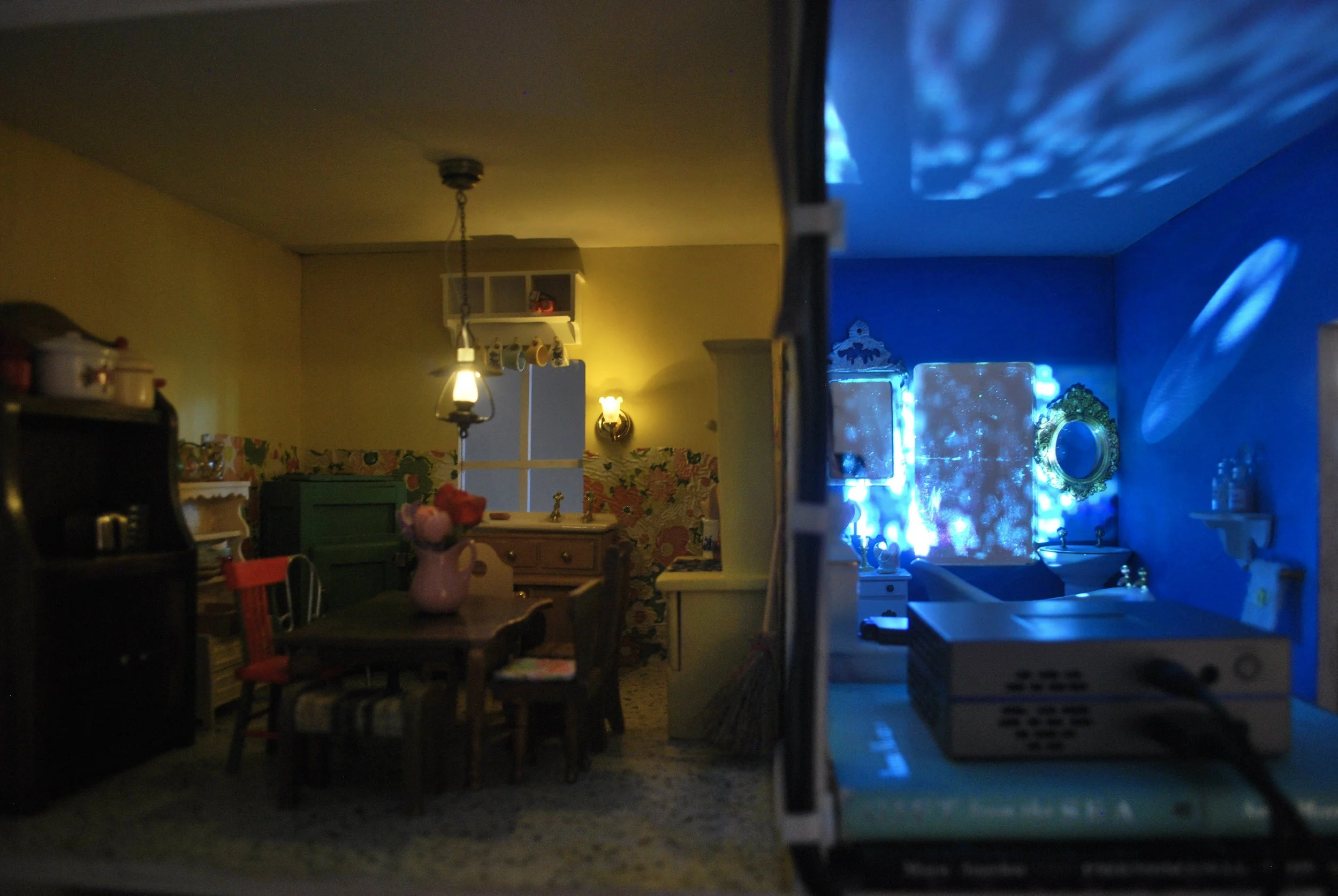 Projected archival family footage inside sculptural dollhouse installation by Hartford artist Lauren Be Dear.