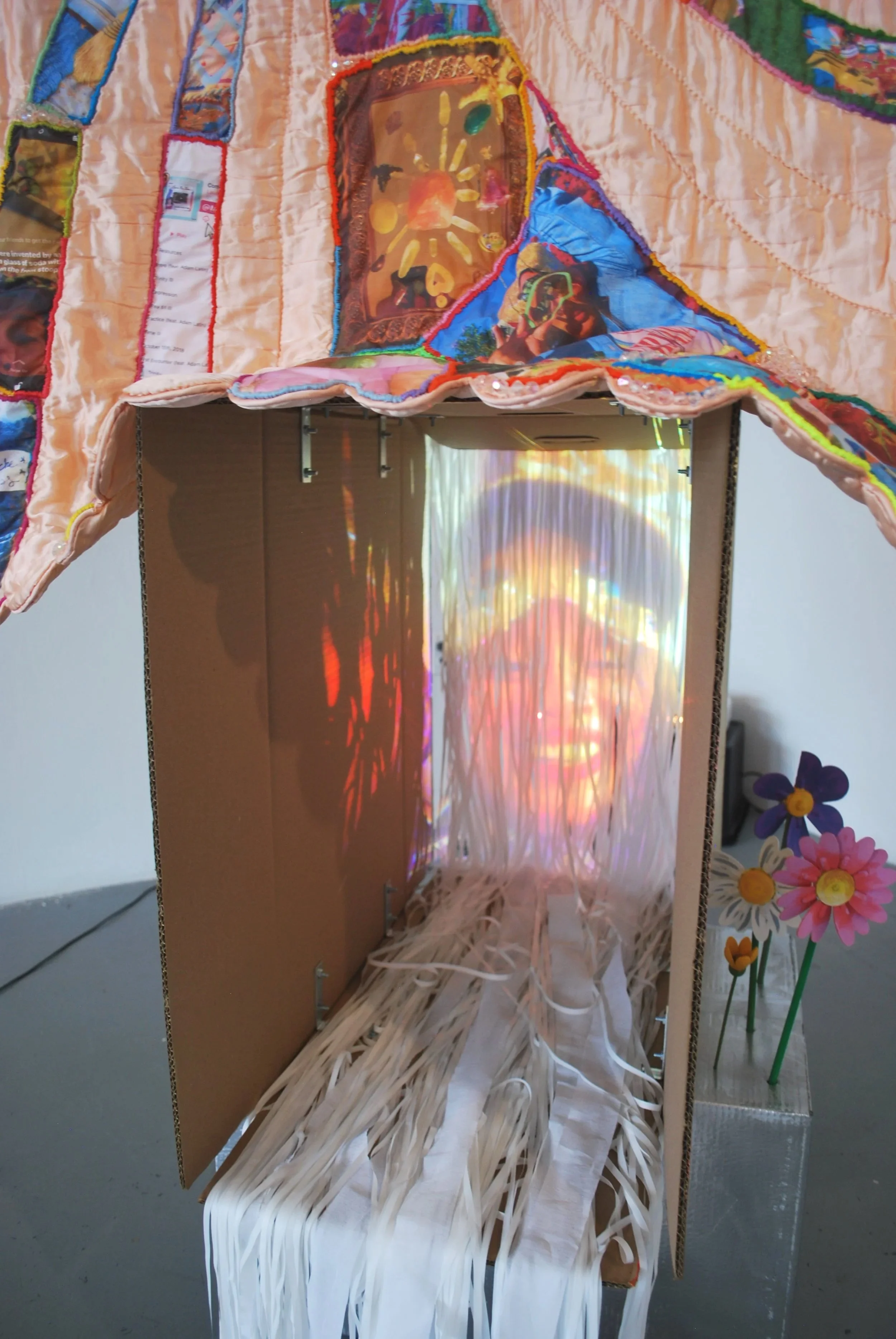Projection detail from Party/Monster multimedia installation featuring layered imagery and stitched fabric elements.