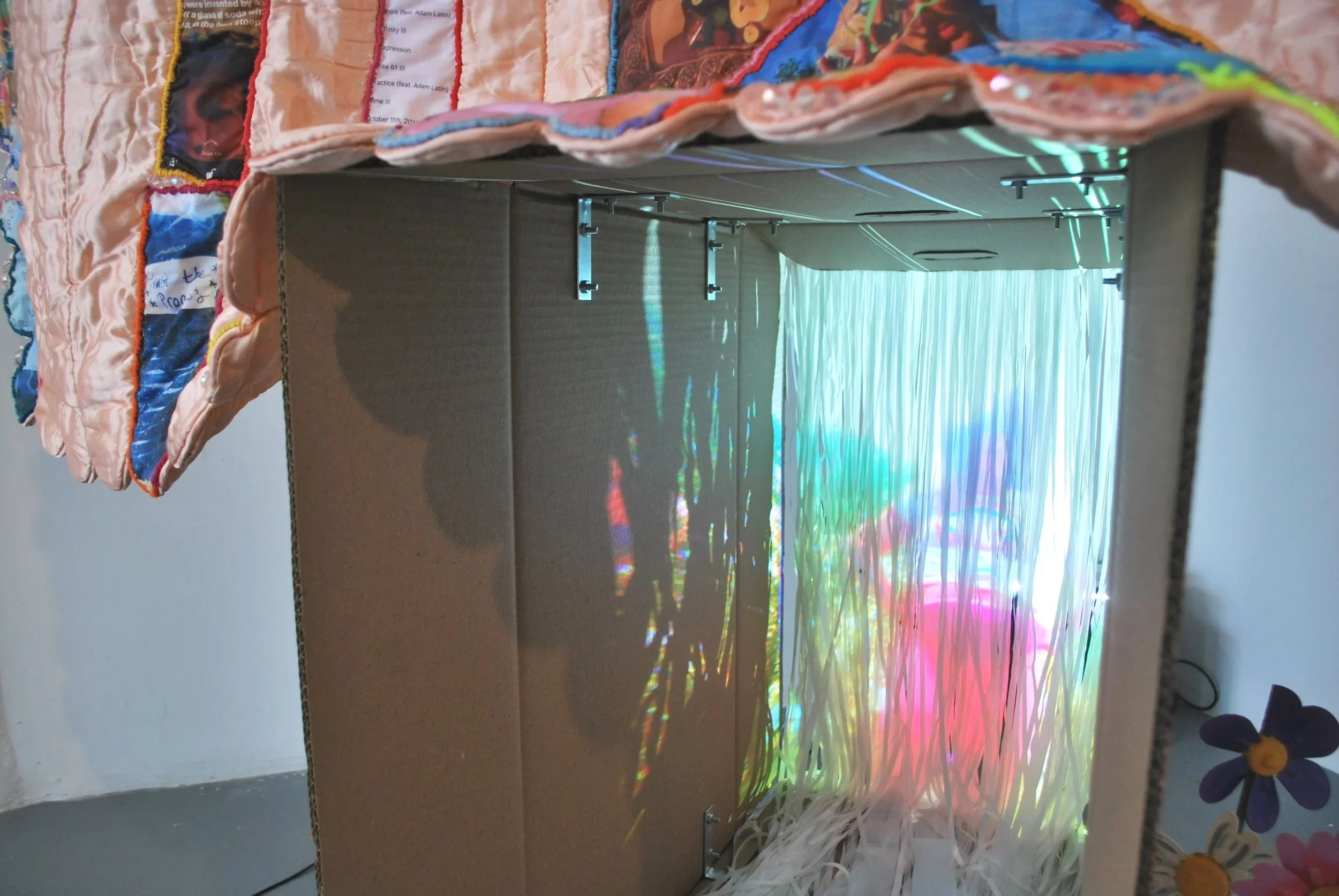 Projection detail from Party/Monster multimedia installation featuring layered imagery and stitched fabric elements.