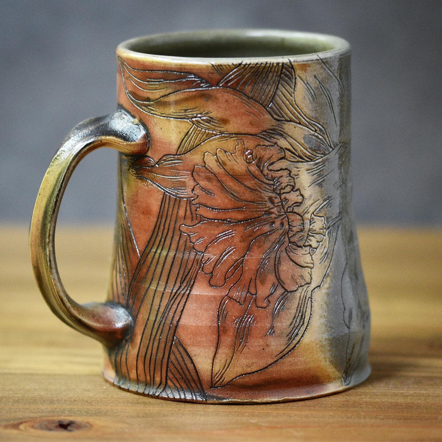 When we pulled this daffodil mug out of the wood kiln, I hated it. H-A-T-E-D-I-T. Yes, in screamy all-caps and stabby little dashes.
 
Back in May, after months of struggling with impaired vision and motor skills, there was a small window of time whe