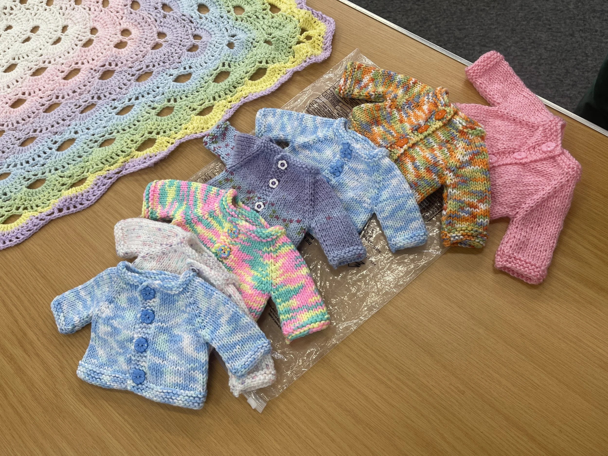 babies cardigans knitted by hand by a needlecraft member to the premies department at James cook hospital