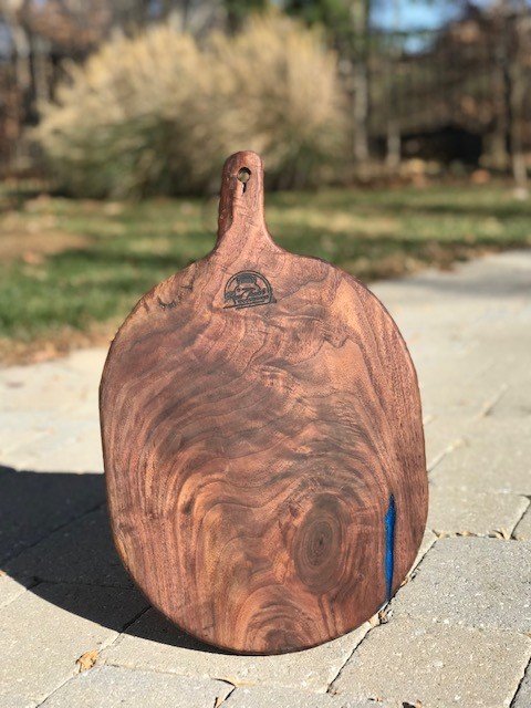 Description: Beautiful Black Walnut Charcuterie board with Blue Epoxy accents.
19" L x 12" W
Price: $125