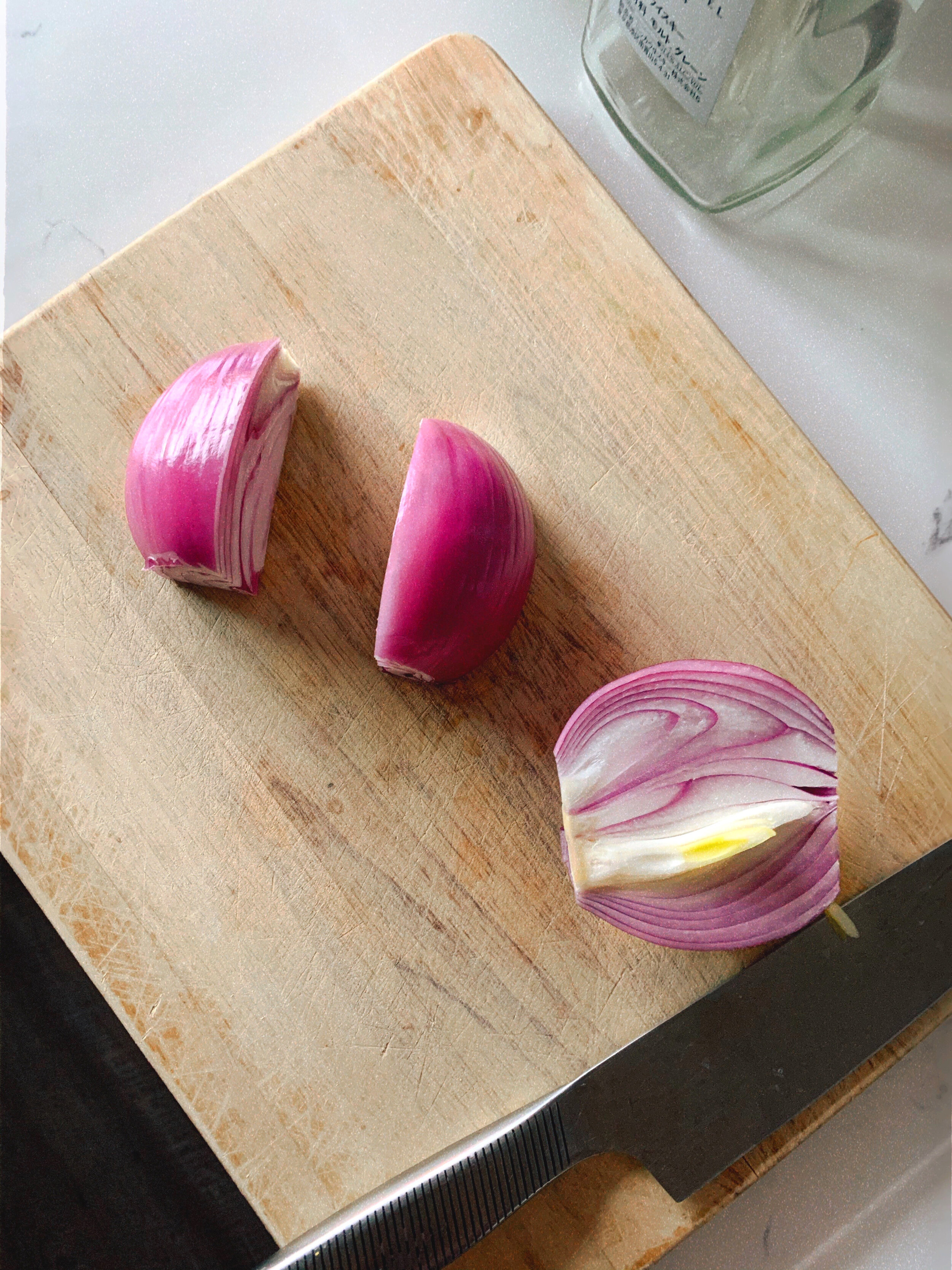 Preparing pickled red onions by quartering the red onion