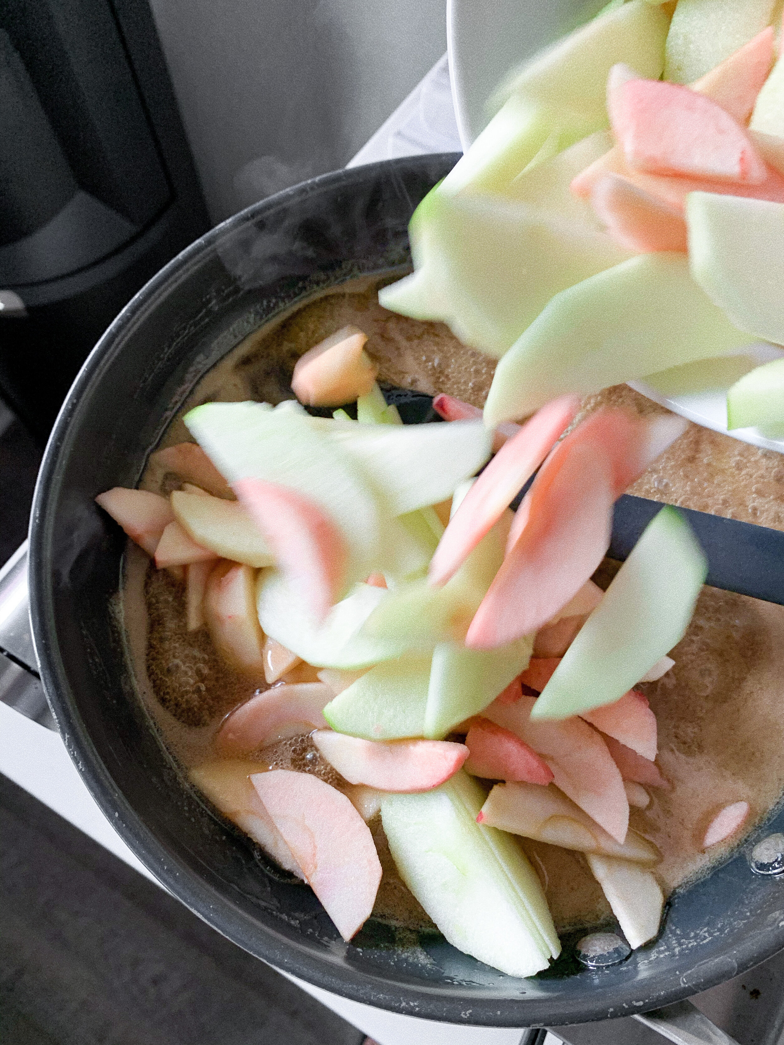 Add the sliced apples to the maple/butter mixture