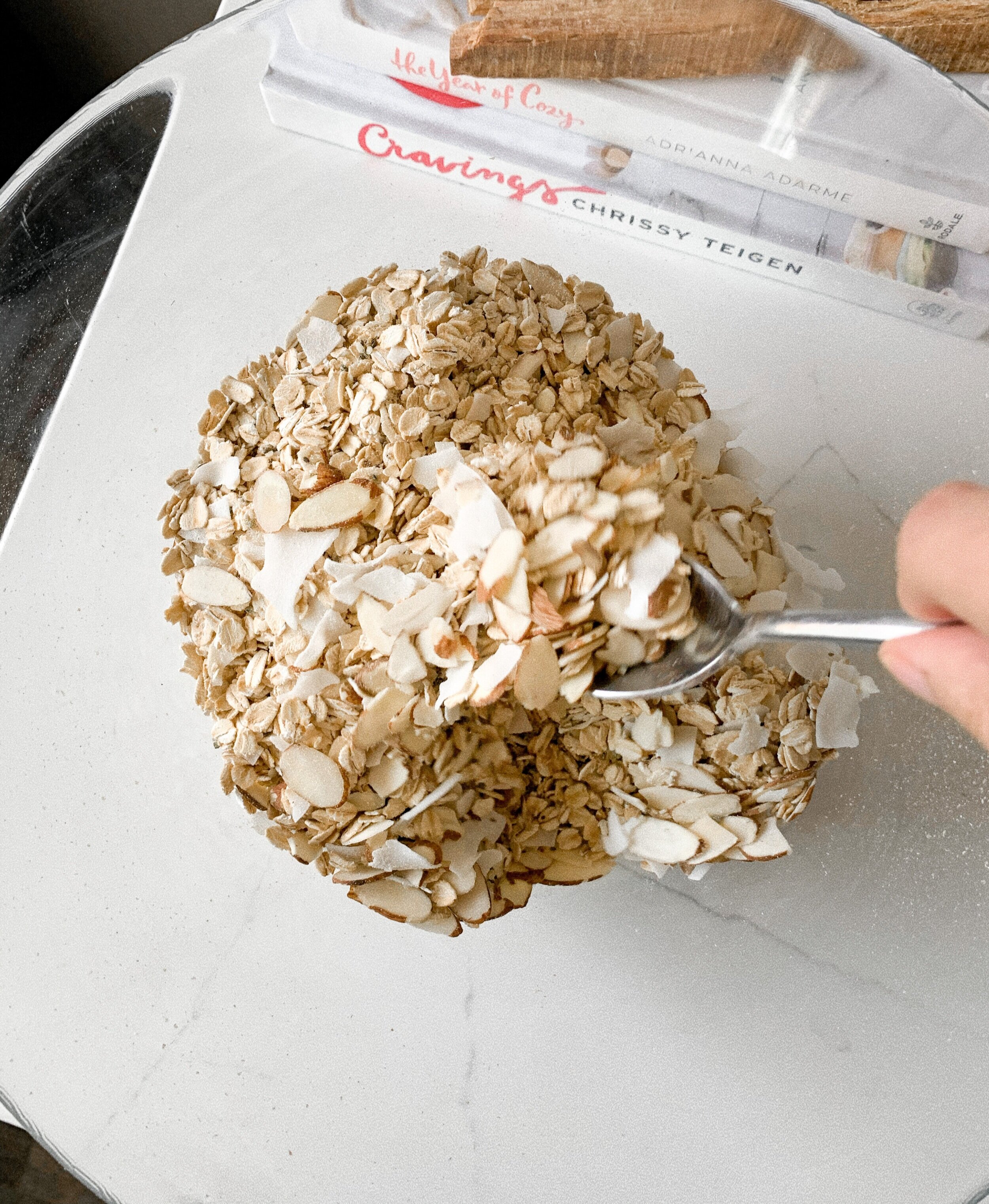 Mixing the homemade coconut cranberry granola ingredients in a mixing bowl
