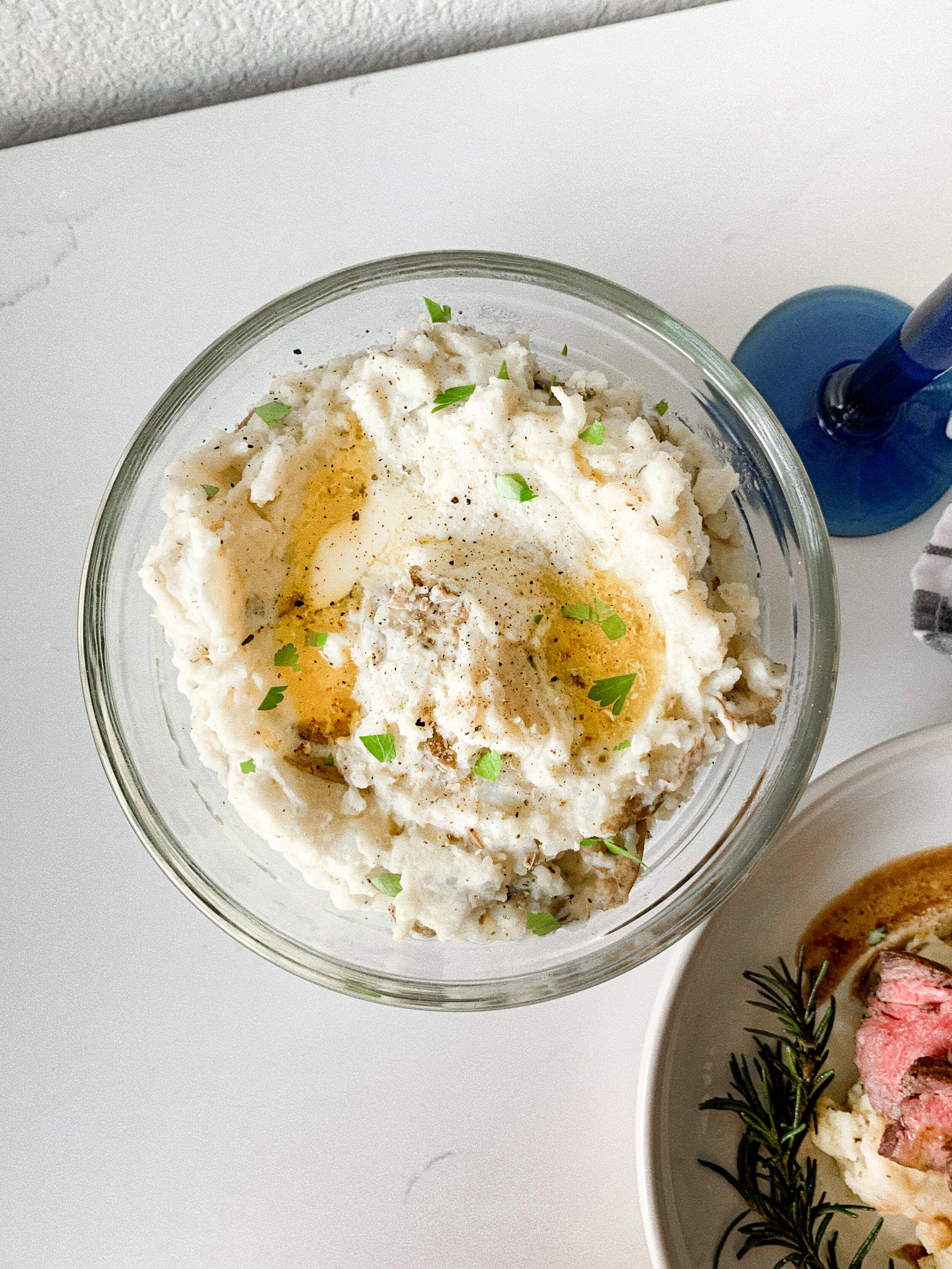 The plated 4-ingredient mashed potatoes topped with melted butter and parsley