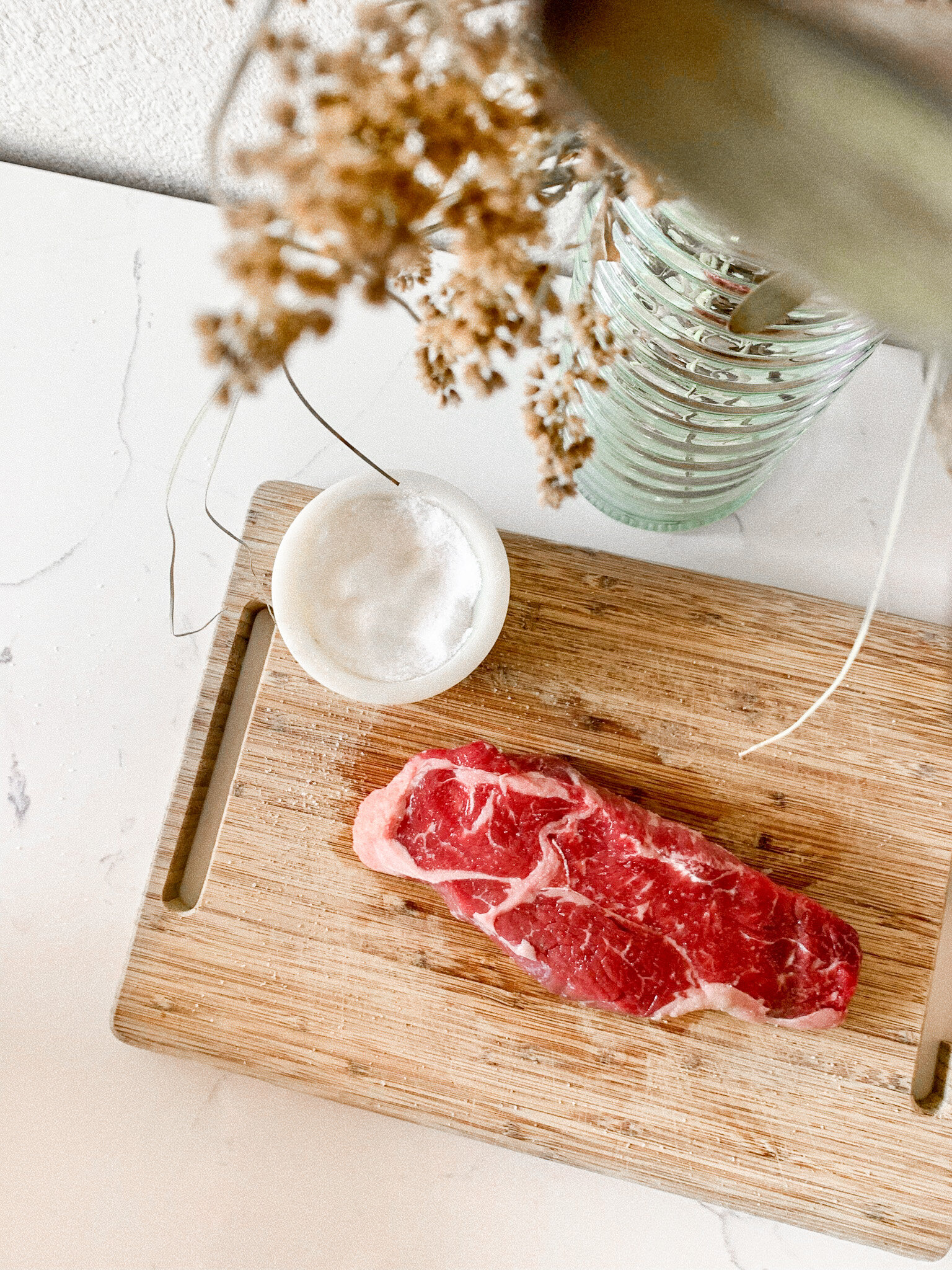 Seasoning the NY-strip steak with salt