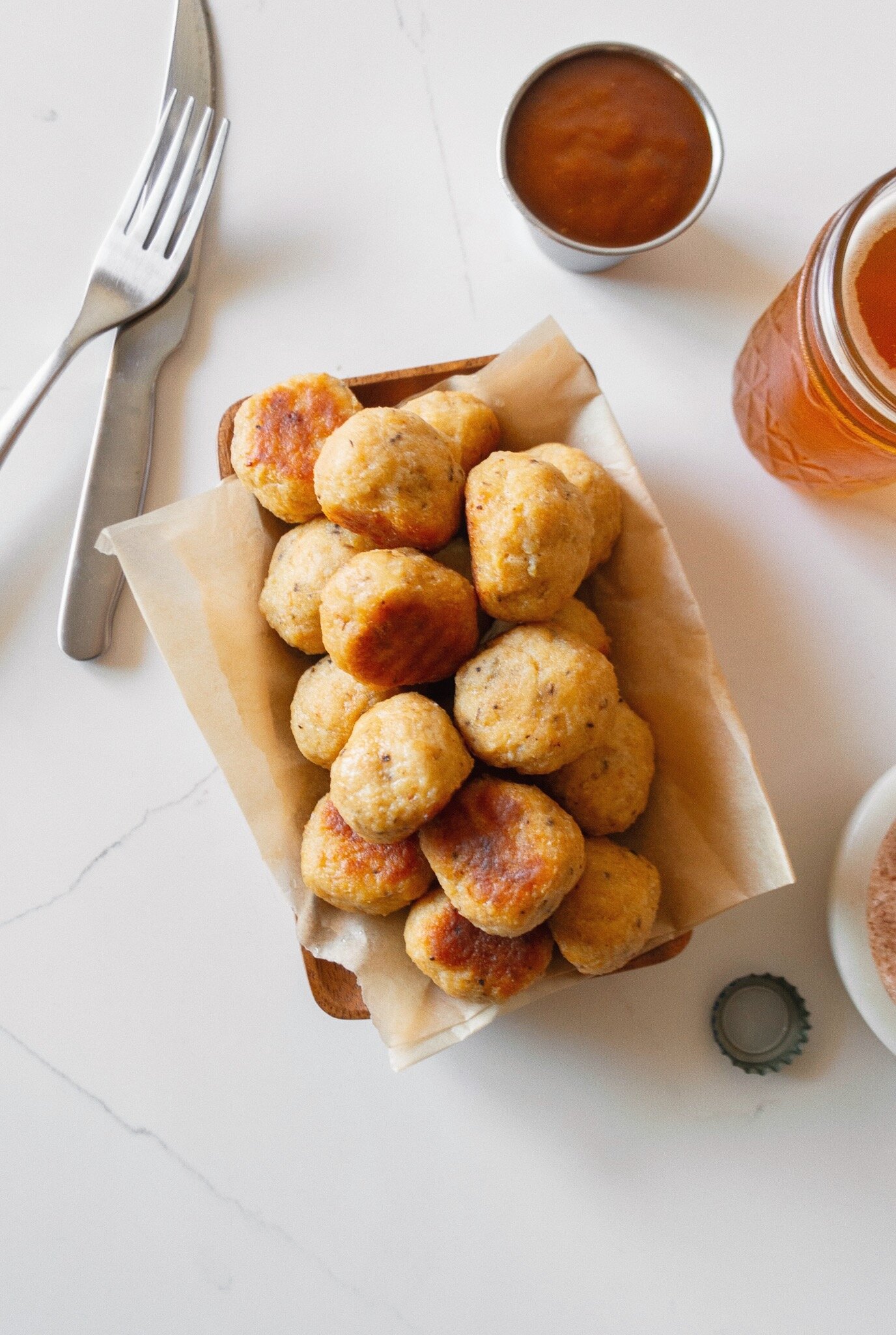 Plated Juicy Oven-Baked Chicken Meatballs with a beer and dipping sauce